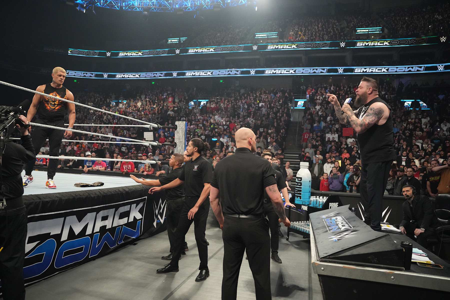 SALT LAKE CITY, UTAH - NOVEMBER 22: Kevin Owens on the microphone and Cody Rhodes during WWE SmackDown at Delta Center on November 22, 2024 in Salt Lake City, Utah.  (Photo by WWE/Getty Images)
