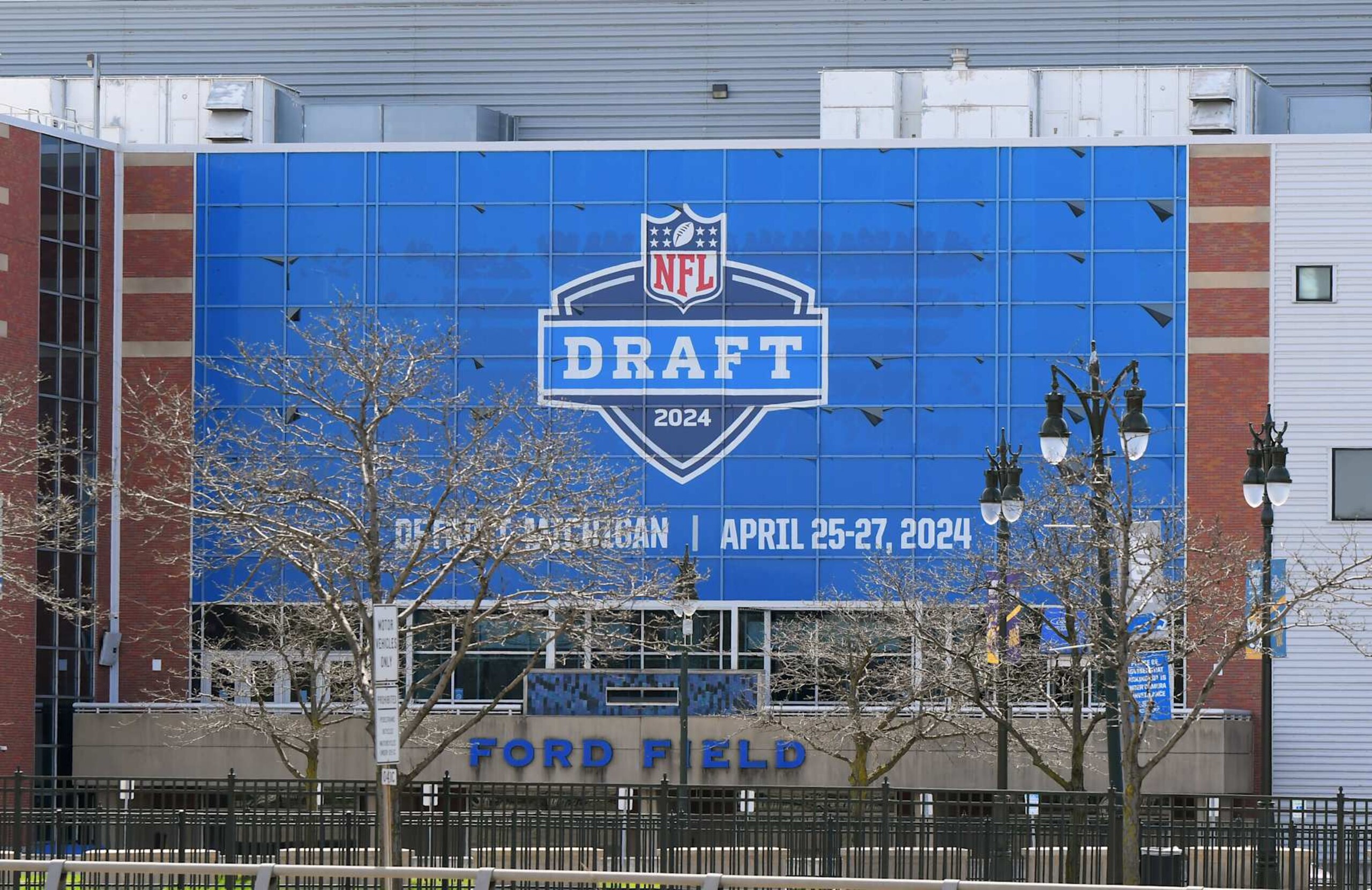 DETROIT, MI - APRIL 18:  A general exterior view of Ford Field, home of the NFL Detroit Lions, with a sign displayed to announce the upcoming NFL draft. The draft is scheduled to be held around Campus Martius Park and Hart Plaza in Detroit, Michigan on April 25Â27, 2024. Photo taken prior to the MLB game between the Detroit Tigers and the Texas Rangers at Comerica Park on April 18, 2024 in Detroit, Michigan.  (Photo by Mark Cunningham/MLB Photos via Getty Images)