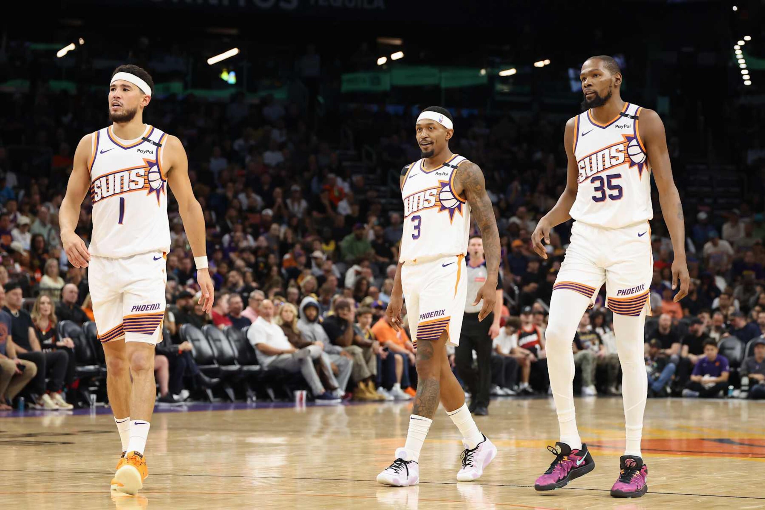 PHOENIX, ARIZONA - OCTOBER 28: (L-R) Devin Booker #1, Bradley Beal #3 and Kevin Durant #35 of the Phoenix Suns walk on the court during the first half of the NBA game against the Los Angeles Lakers at Footprint Center on October 28, 2024 in Phoenix, Arizona. The Suns defeated the Lakers 109-105. NOTE TO USER: User expressly acknowledges and agrees that, by downloading and/or using this photograph, user is consenting to the terms and conditions of the Getty Images License Agreement. (Photo by Christian Petersen/Getty Images) PHOENIX, ARIZONA - OCTOBER 28: (L-R) Devin Booker #1, Bradley Beal #3 and Kevin Durant #35 of the Phoenix Suns walk on the court during the first half of the NBA game against the Los Angeles Lakers at Footprint Center on October 28, 2024 in Phoenix, Arizona. The Suns defeated the Lakers 109-105. NOTE TO USER: User expressly acknowledges and agrees that, by downloading and/or using this photograph, user is consenting to the terms and conditions of the Getty Images License Agreement. (Photo by Christian Petersen/Getty Images)