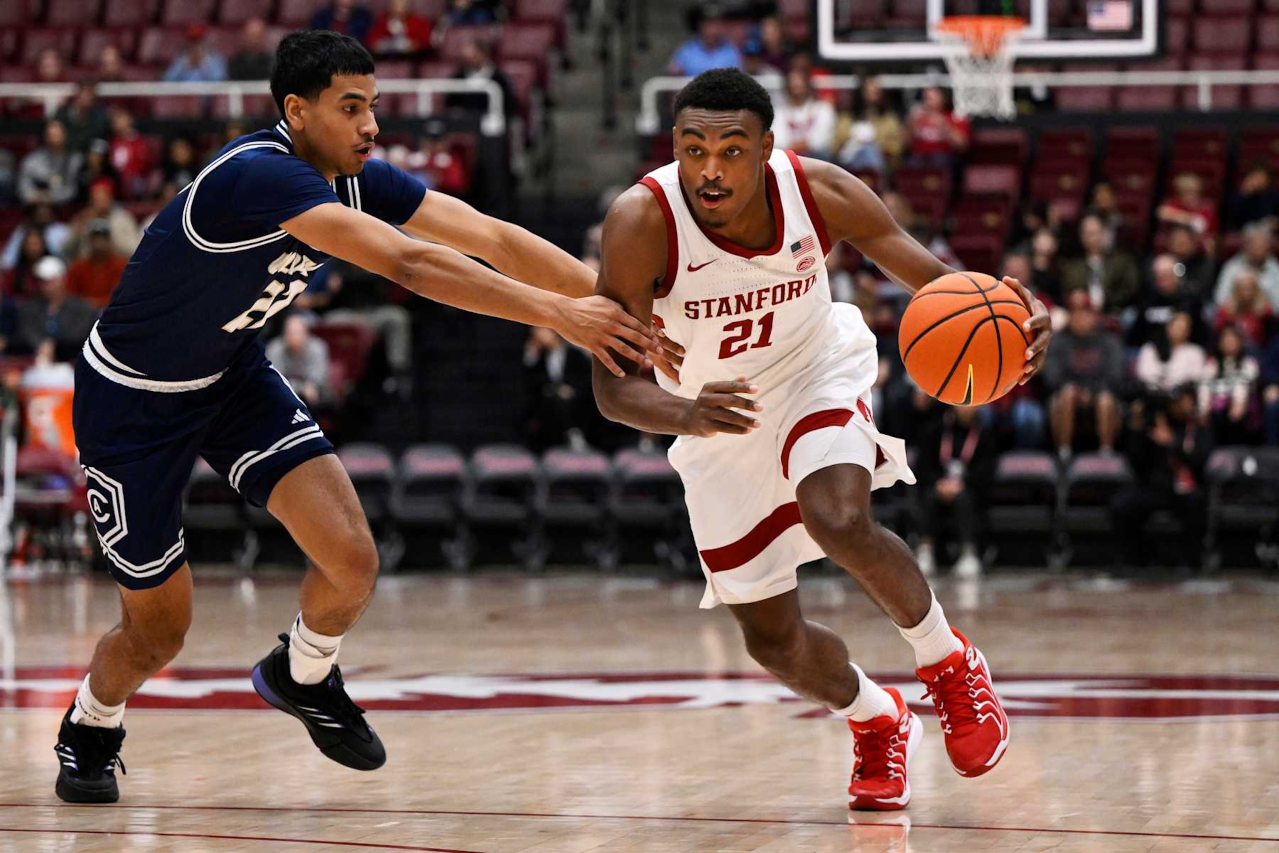 PALO ALTO, CALIFORNIA - NOVEMBER 17: Jaylen Blakes #21 of the Stanford Cardinal drives to the basket against Sione Lose #22 of the UC Davis Aggies in the first half at Stanford Maples Pavilion on November 17, 2024 in Palo Alto, California. (Photo by Eakin Howard/Getty Images) PALO ALTO, CALIFORNIA - NOVEMBER 17: Jaylen Blakes #21 of the Stanford Cardinal drives to the basket against Sione Lose #22 of the UC Davis Aggies in the first half at Stanford Maples Pavilion on November 17, 2024 in Palo Alto, California. (Photo by Eakin Howard/Getty Images)