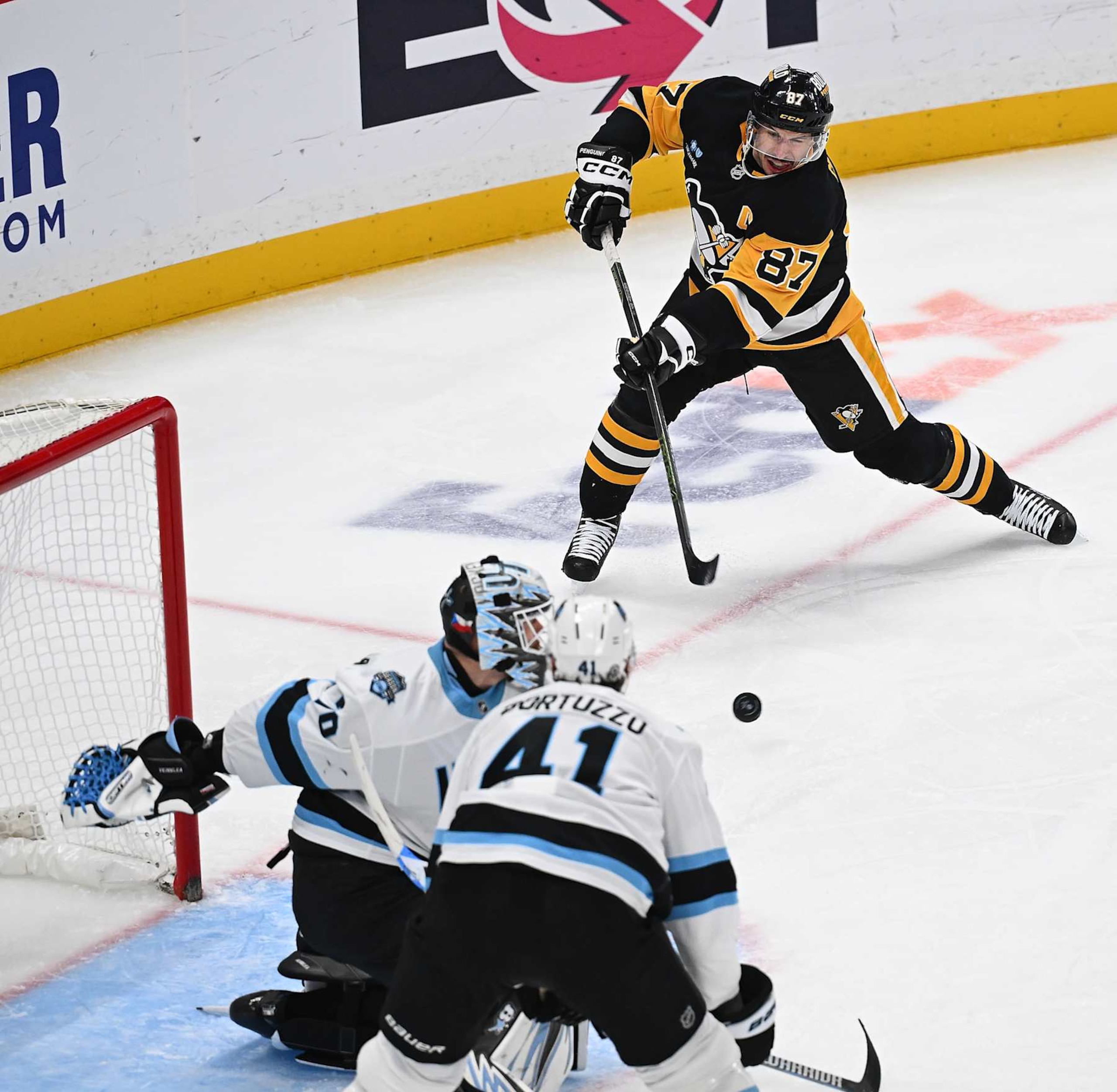 PITTSBURGH, PENNSYLVANIA - NOVEMBER 23: Sidney Crosby #87 of the Pittsburgh Penguins scores a goal past Karel Vejmelka #70 of the Utah Hockey Club for his 600th career goal in the second period during the game at PPG PAINTS Arena on November 23, 2024 in Pittsburgh, Pennsylvania. (Photo by Justin Berl/Getty Images)