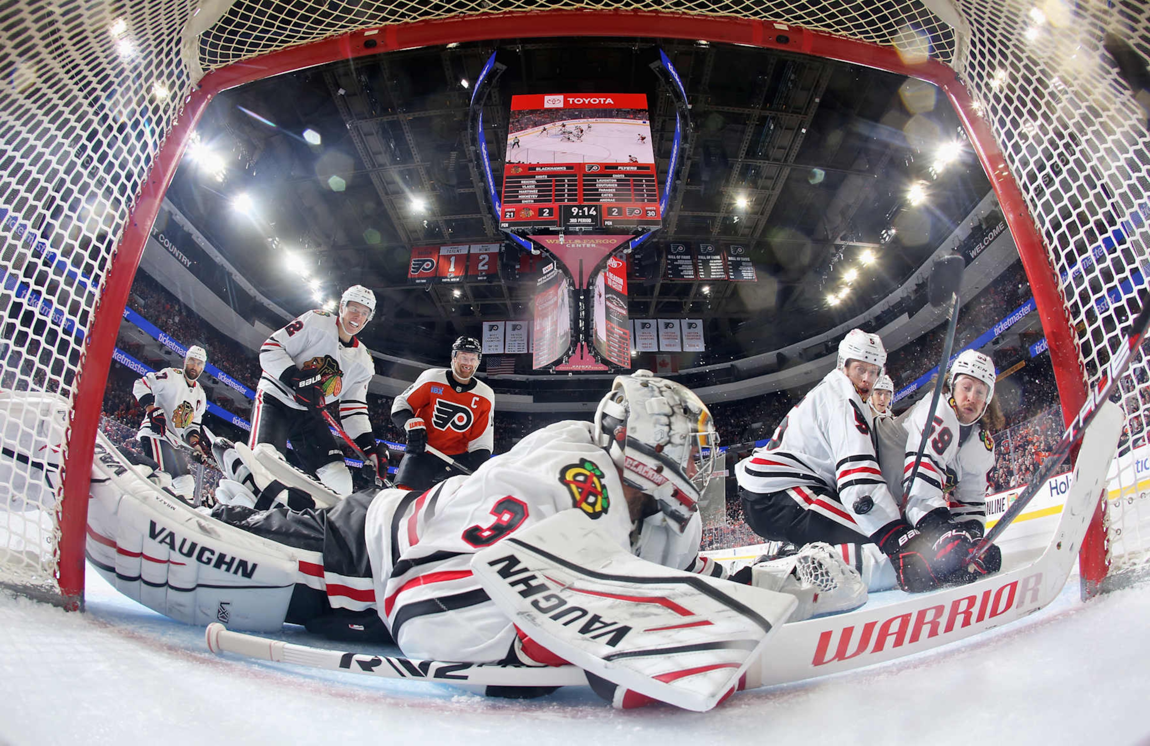 PHILADELPHIA, PENNSYLVANIA - NOVEMBER 23: Goaltender Petr Mrazek #34 of the Chicago Blackhawks lunges across his crease as teammates Nick Foligno #17, Alex Vlasic #72, Connor Murphy #5, and Tyler Bertuzzi #59 defend against Sean Couturier #14 of the Philadelphia Flyers at the Wells Fargo Center on November 23, 2024 in Philadelphia, Pennsylvania. The Flyers went on to defeat the Blackhawks 3-2 in overtime. (Photo by Len Redkoles/NHLI via Getty Images)