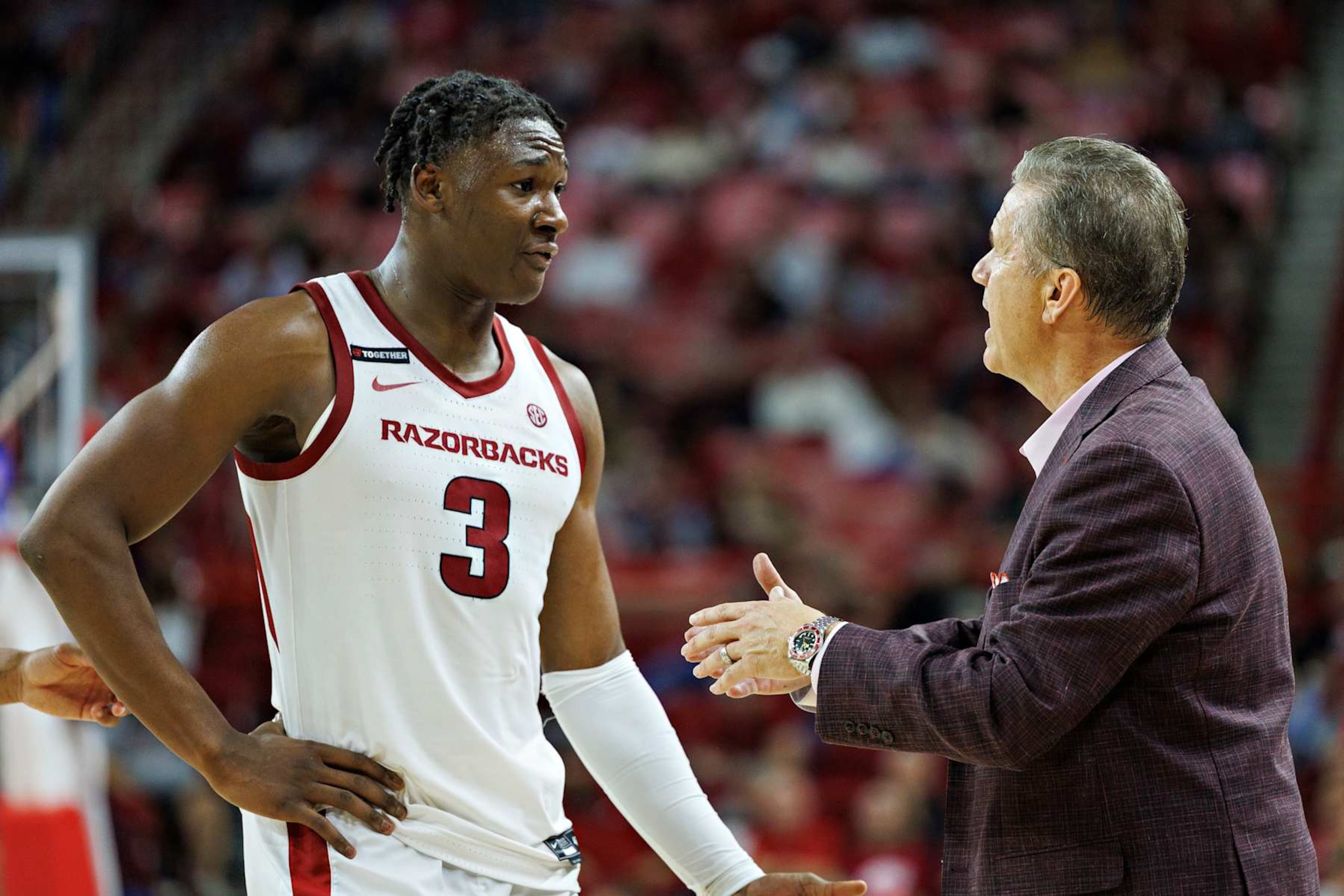 FAYETTEVILLE, ARKANSAS - NOVEMBER 22: Head Coach John Calipari talks with Adou Thiero #3 of the Arkansas Razorbacks in the second half of a game against the UALR Trojans at Bud Walton Arena on November 22, 2024 in Fayetteville, Arkansas. The Razorbacks defeated the Trojans 79-67. (Photo by Wesley Hitt/Getty Images) FAYETTEVILLE, ARKANSAS - NOVEMBER 22: Head Coach John Calipari talks with Adou Thiero #3 of the Arkansas Razorbacks in the second half of a game against the UALR Trojans at Bud Walton Arena on November 22, 2024 in Fayetteville, Arkansas. The Razorbacks defeated the Trojans 79-67. (Photo by Wesley Hitt/Getty Images)