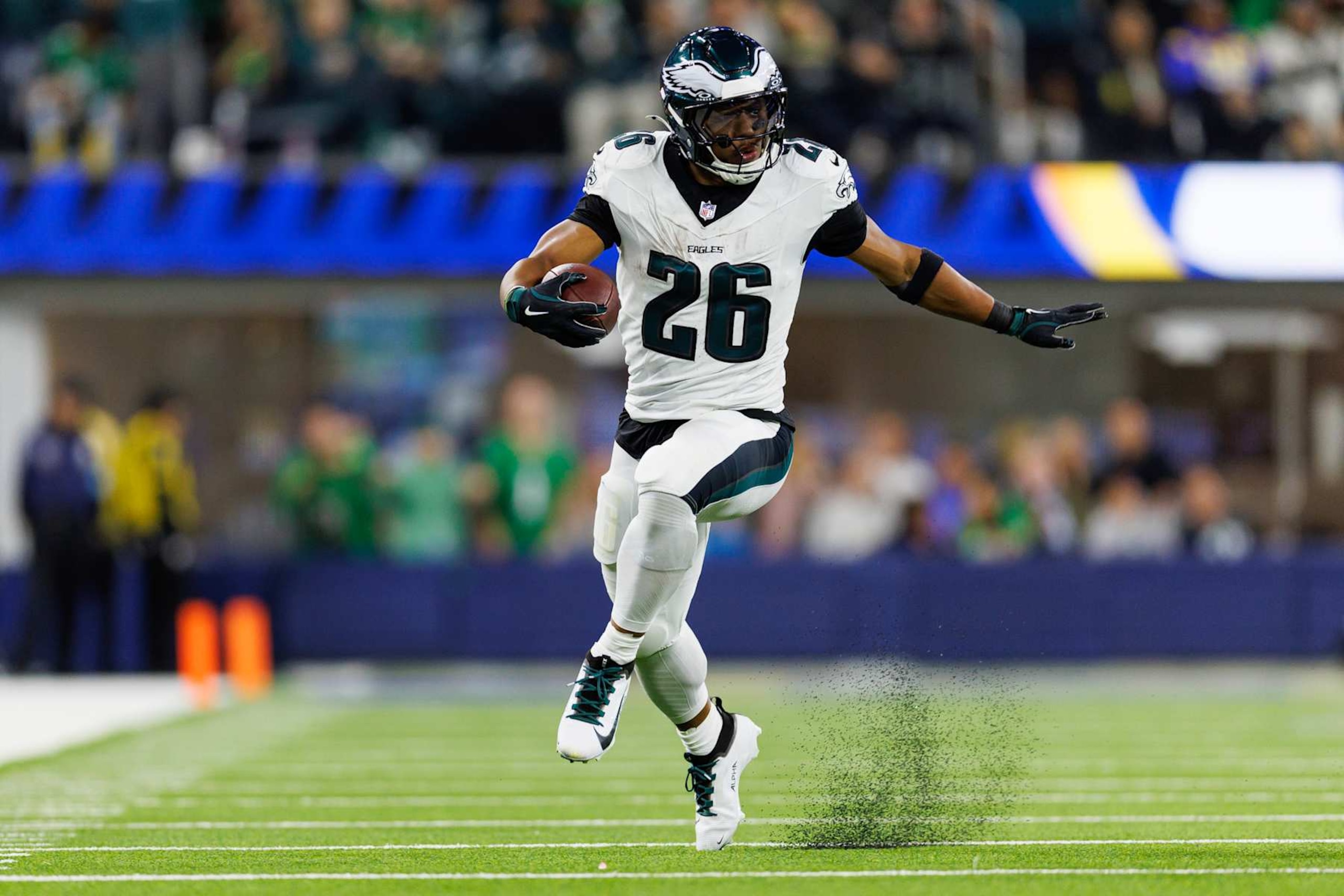 INGLEWOOD, CALIFORNIA - NOVEMBER 24: Running back Saquon Barkley #26 of the Philadelphia Eagles carries the ball during the first half of an NFL football game against the Los Angeles Rams, at SoFi Stadium on November 24, 2024 in Inglewood, California. (Photo by Brooke Sutton/Getty Images)