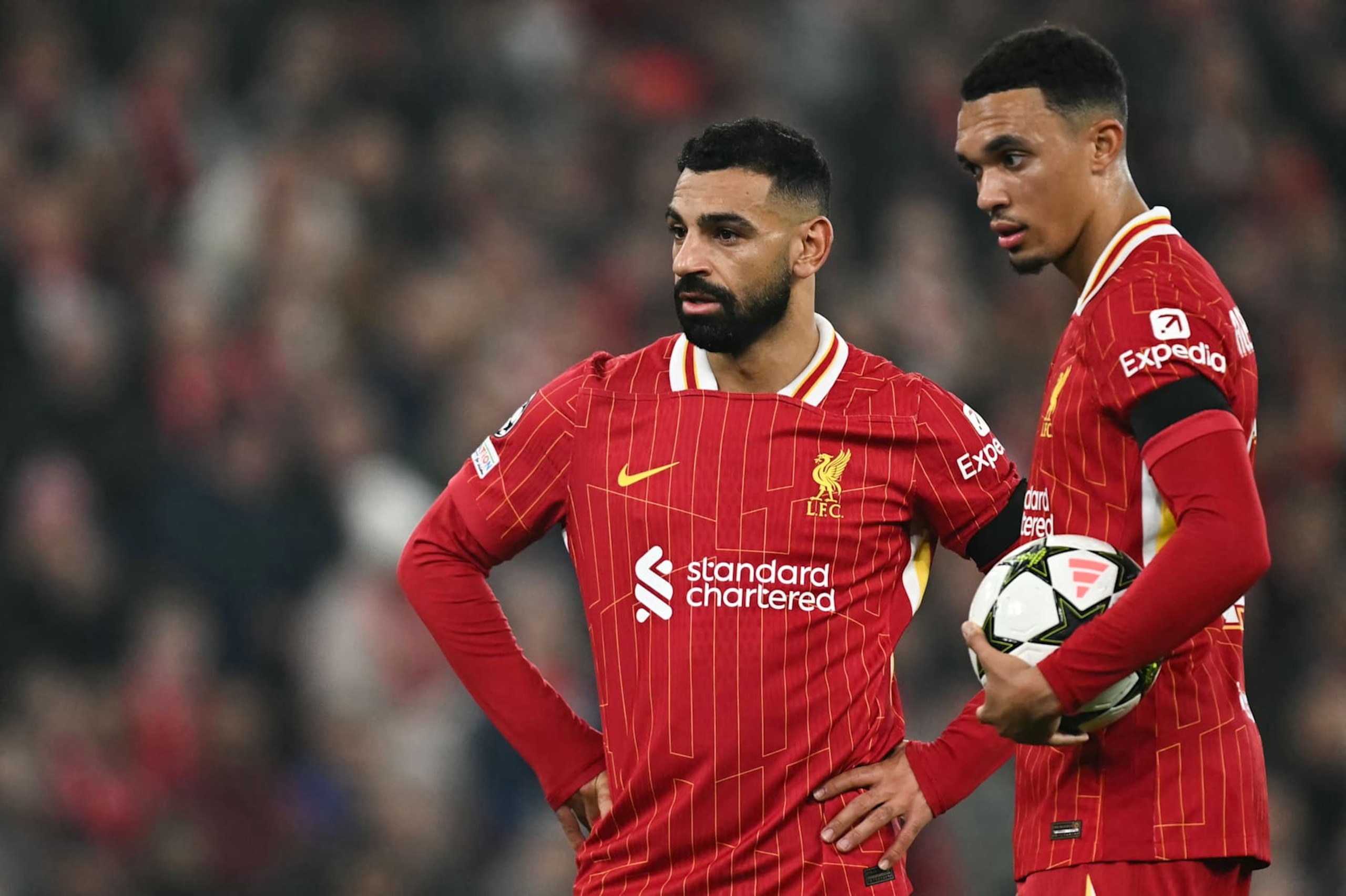 Liverpool's Egyptian striker #11 Mohamed Salah (L) and Liverpool's English defender #66 Trent Alexander-Arnold speak together as they prepare for a free kick during the UEFA Champions League football match between Liverpool and Bayer Leverkusen at Anfield stadium, in Liverpool, north west England, on November 5, 2024. (Photo by Paul ELLIS / AFP) (Photo by PAUL ELLIS/AFP via Getty Images)