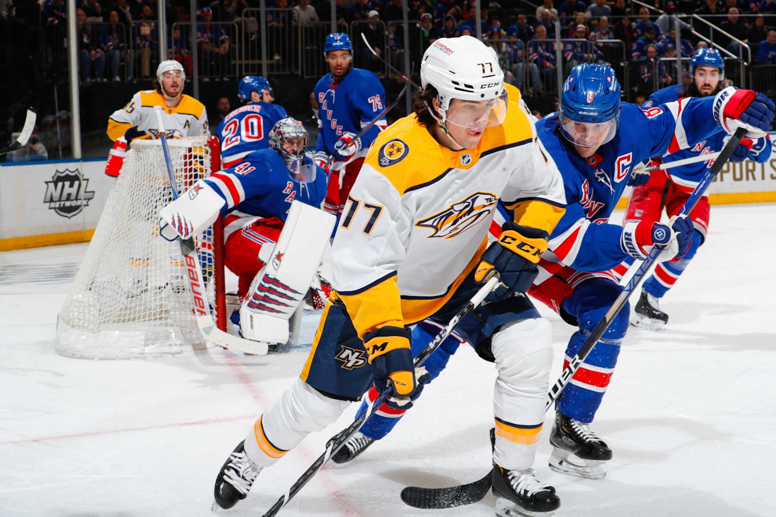 NEW YORK, NEW YORK - MARCH 19:  Luke Evangelista #77 of the Nashville Predators skates with the puck against Jacob Trouba #8 of the New York Rangers at Madison Square Garden on March 19, 2023 in New York City. (Photo by Jared Silber/NHLI via Getty Images)
