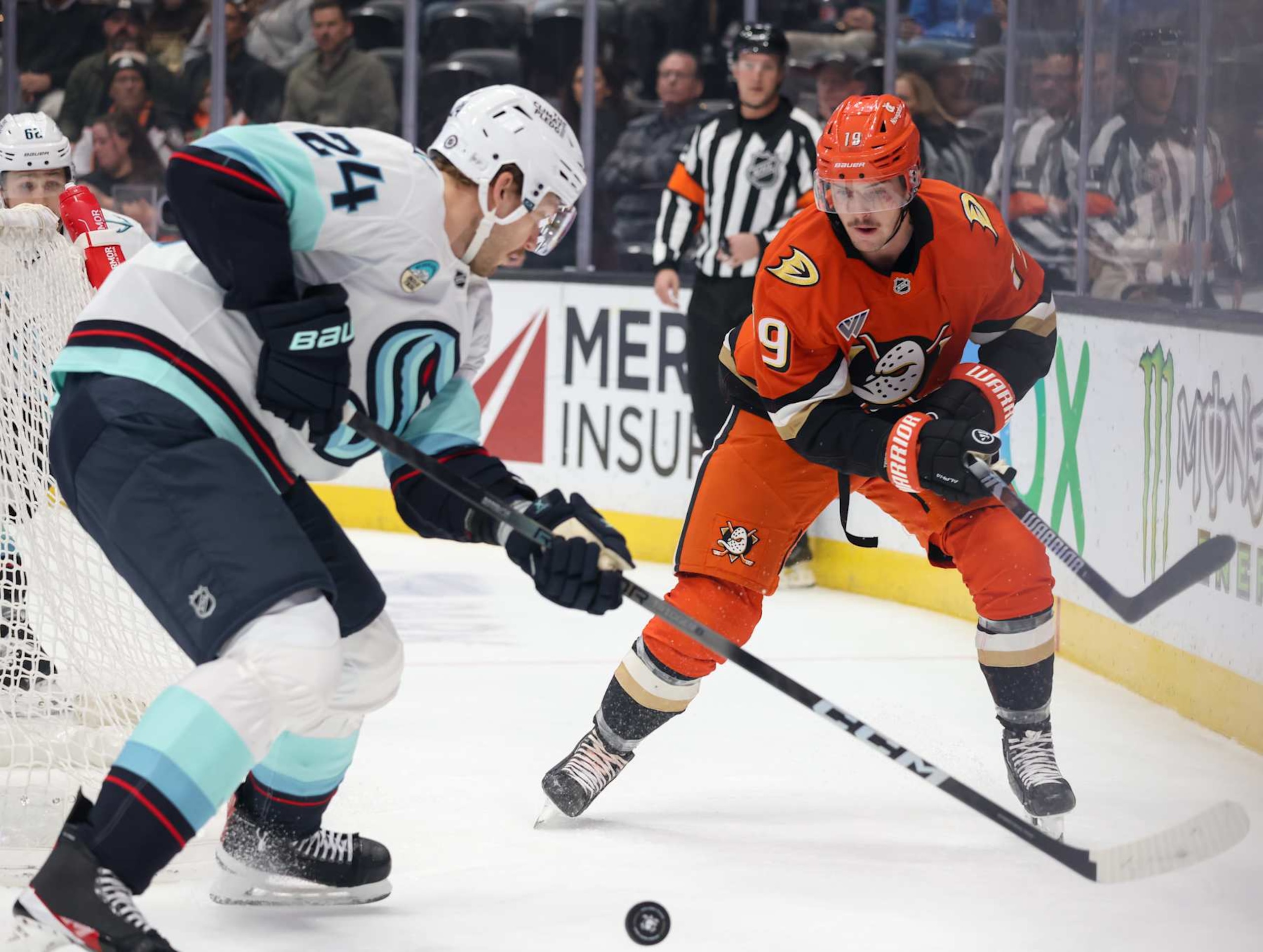 ANAHEIM, CA - NOVEMBER 25:  Jamie Oleksiak #24 of the Seattle Kraken and Troy Terry #19 of the Anaheim Ducks battle for the puck during the first period at Honda Center on November 25, 2024 in Anaheim, California. (Photo by Debora Robinson/NHLI via Getty Images)