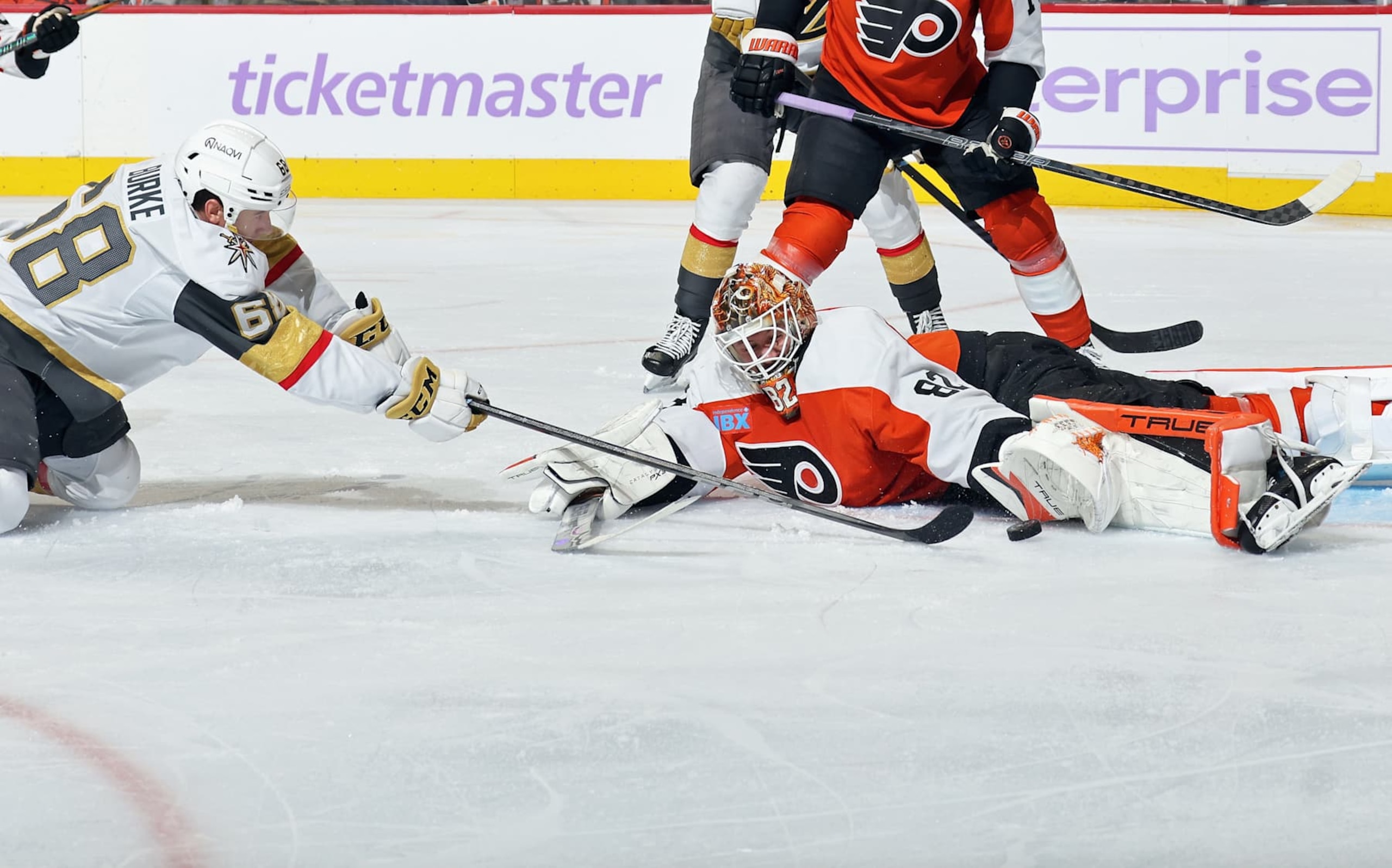 PHILADELPHIA, PENNSYLVANIA - NOVEMBER 25: Goaltender Ivan Fedotov #82 of the Philadelphia Flyers lunges across his crease to make a glove save on a scoring chance by Callahan Burke #68 of the Vegas Golden Knights at the Wells Fargo Center on November 25, 2024 in Philadelphia, Pennsylvania.  (Photo by Len Redkoles/NHLI via Getty Images)