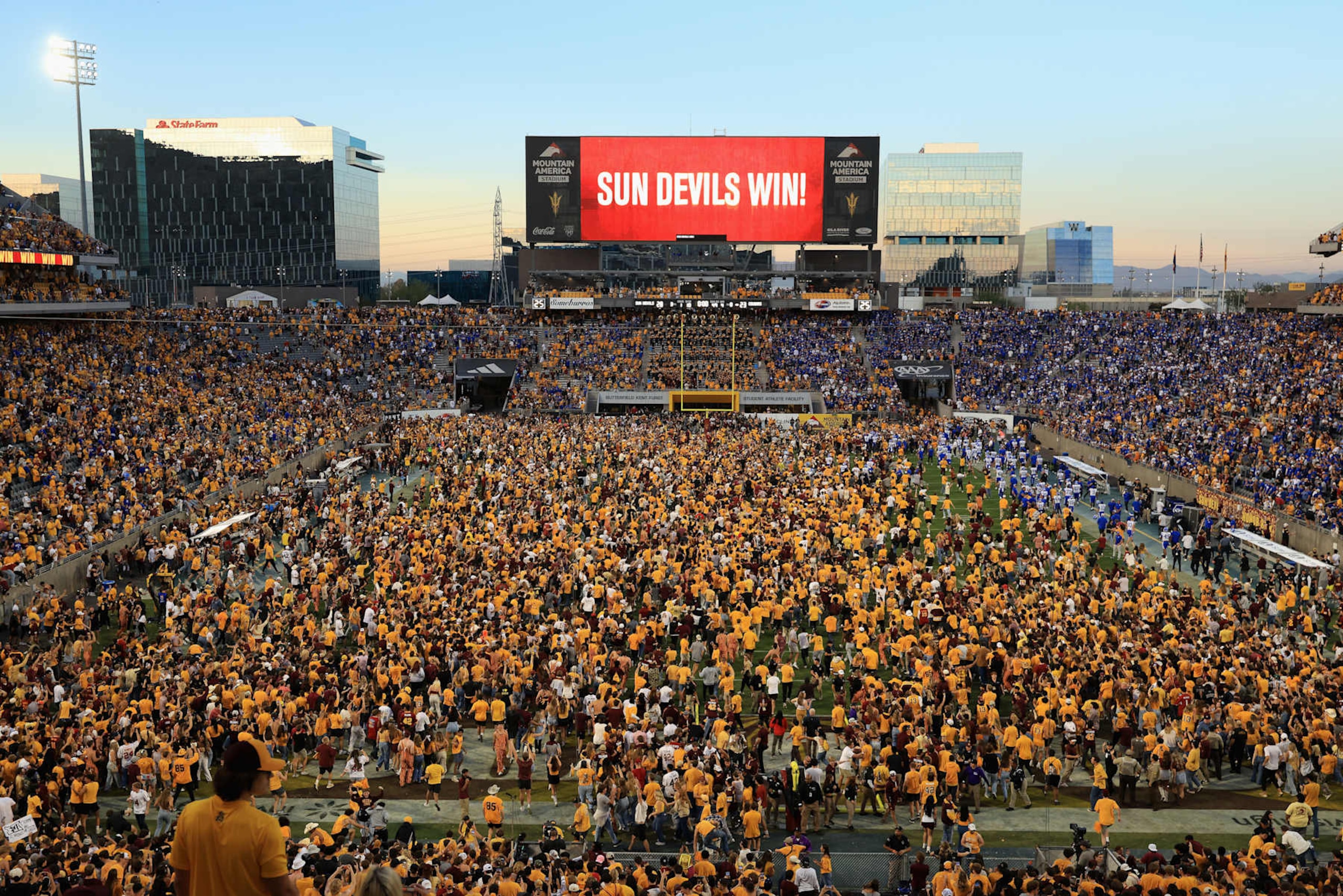 Arizona State fans rush the field after a resumption of play with 1 second left on the clock vs. BYU