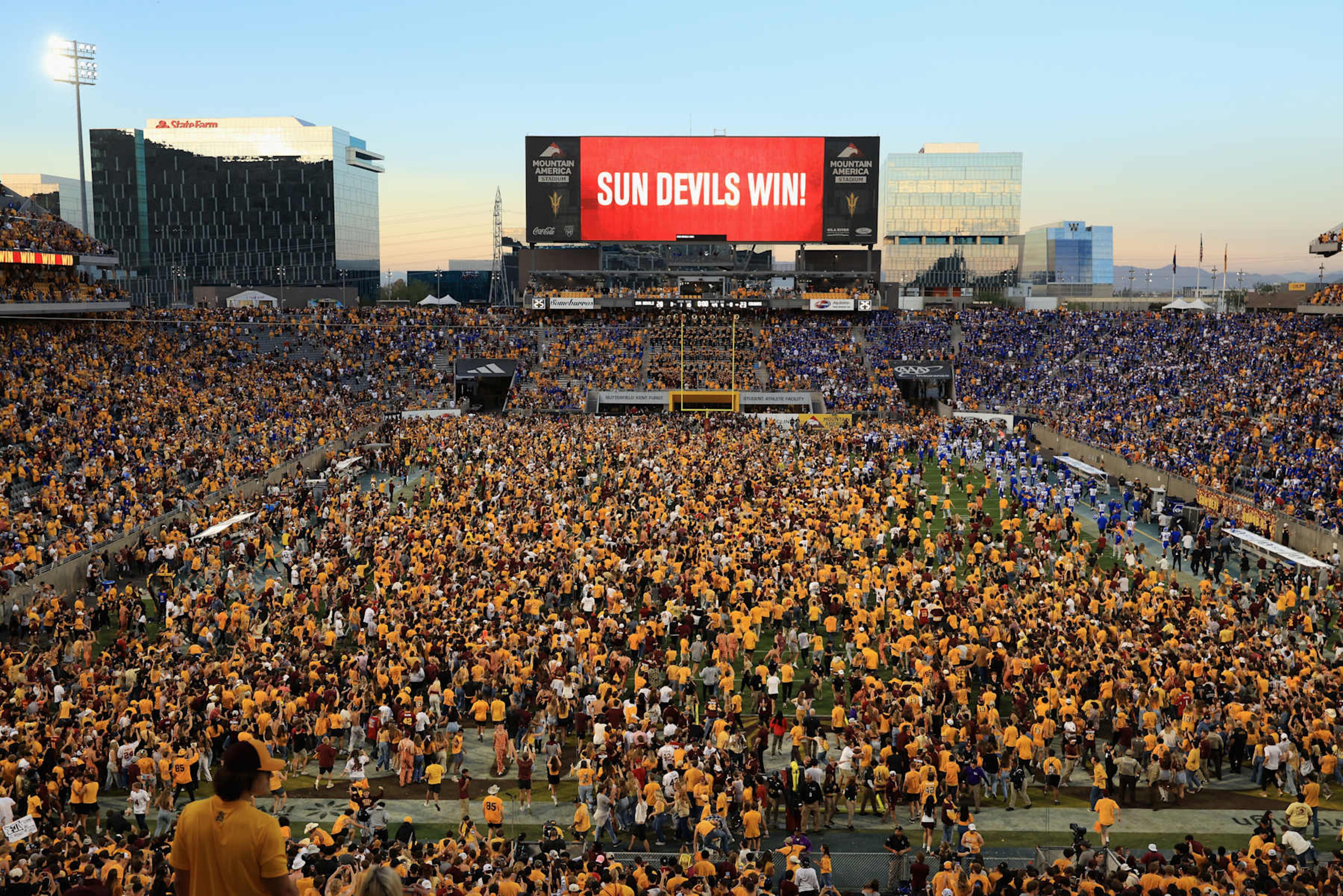 Arizona State fans rush the field after a resumption of play with 1 second left on the clock vs. BYU