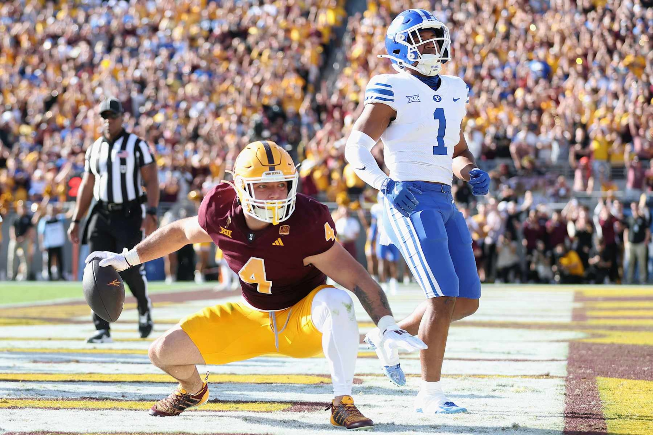 TEMPE, ARIZONA - NOVEMBER 23: Cam Skattebo #4 of the Arizona State Sun Devils reacts after scoring a four-yard rushing touchdown against the Brigham Young Cougars during the first half of the NCAAF game at Mountain America Stadium on November 23, 2024 in Tempe, Arizona. The Sun Devils defeated the Cougars 28-23. (Photo by Christian Petersen/Getty Images)