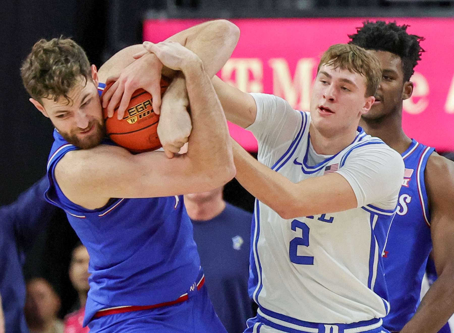 LAS VEGAS, NEVADA - NOVEMBER 26: Hunter Dickinson #1 of the Kansas Jayhawks ties up Cooper Flagg #2 of the Duke Blue Devils for a jump ball in the first half of a game during the Vegas Showdown at T-Mobile Arena on November 26, 2024 in Las Vegas, Nevada. (Photo by Ethan Miller/Getty Images)