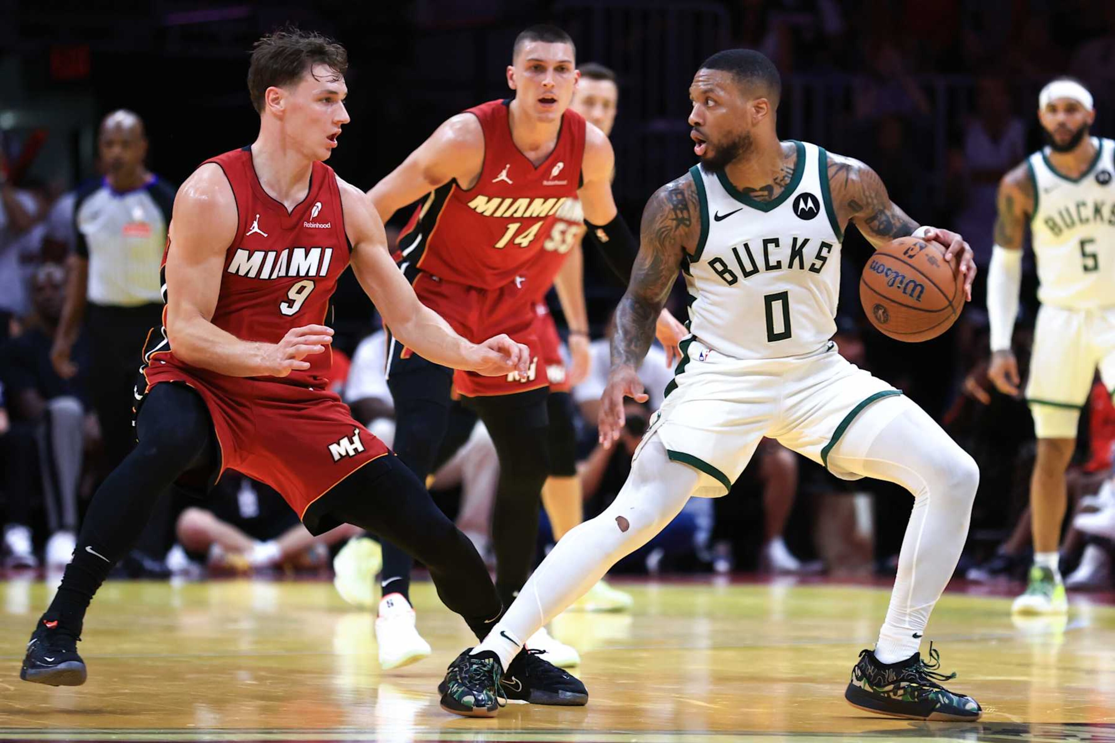 MIAMI, FLORIDA - NOVEMBER 26: Damian Lillard #0 of the Milwaukee Bucks dribbles the ball against Pelle Larsson #9 of the Miami Heat during the third quarter at Kaseya Center on November 26, 2024 in Miami, Florida. NOTE TO USER: User expressly acknowledges and agrees that, by downloading and or using this photograph, User is consenting to the terms and conditions of the Getty Images License Agreement. (Photo by Megan Briggs/Getty Images) MIAMI, FLORIDA - NOVEMBER 26: Damian Lillard #0 of the Milwaukee Bucks dribbles the ball against Pelle Larsson #9 of the Miami Heat during the third quarter at Kaseya Center on November 26, 2024 in Miami, Florida. NOTE TO USER: User expressly acknowledges and agrees that, by downloading and or using this photograph, User is consenting to the terms and conditions of the Getty Images License Agreement. (Photo by Megan Briggs/Getty Images)