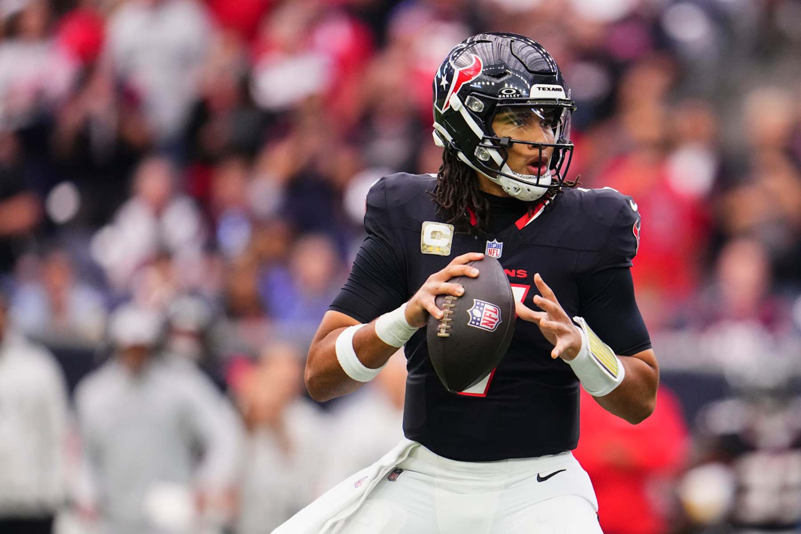 HOUSTON, TX - NOVEMBER 24: C.J. Stroud #7 of the Houston Texans drops back to pass against the Tennessee Titans during the first half of an NFL football game at NRG Stadium on November 24, 2024 in Houston, Texas. (Photo by Cooper Neill/Getty Images)
