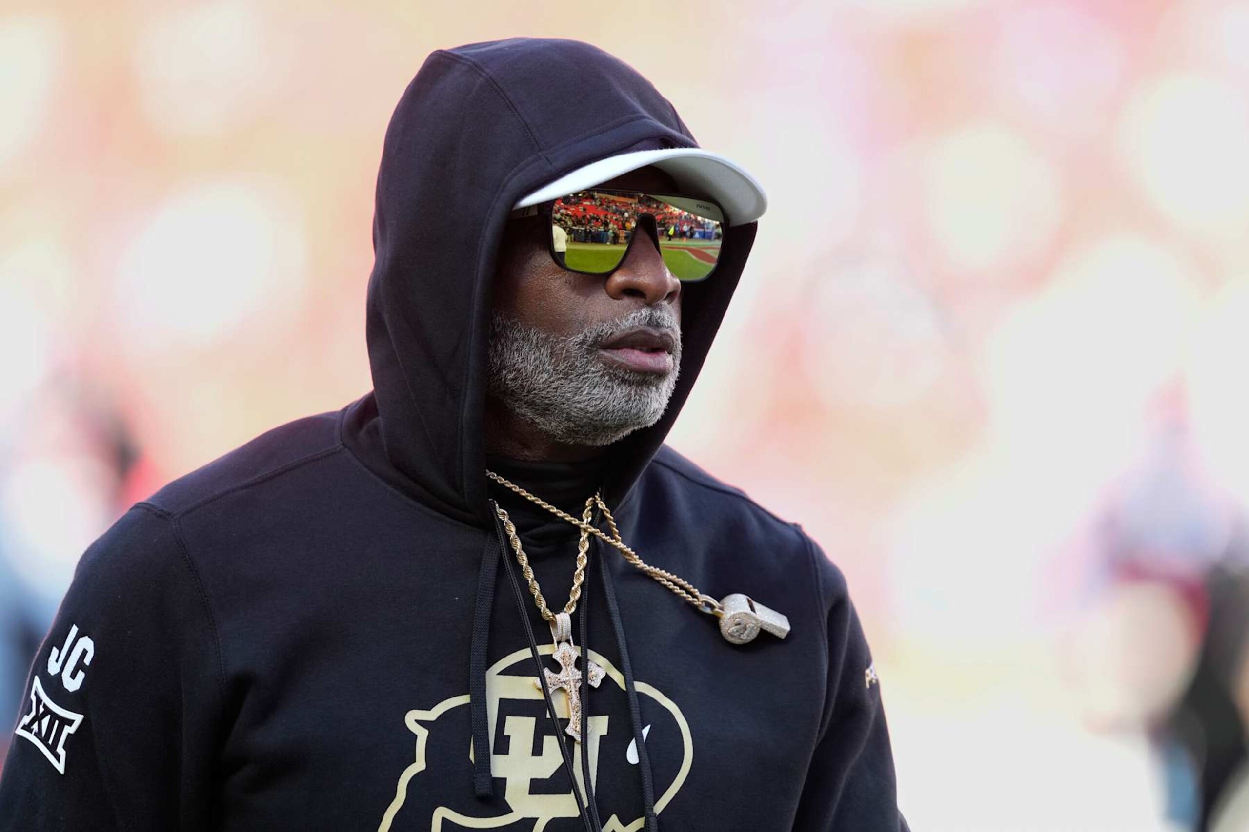 KANSAS CITY, MISSOURI - NOVEMBER 23: Head coach Deion Sanders of the Colorado Buffaloes watches his team warm up prior to a game against the Kansas Jayhawks at Arrowhead Stadium on November 23, 2024 in Kansas City, Missouri.  (Photo by Ed Zurga/Getty Images)