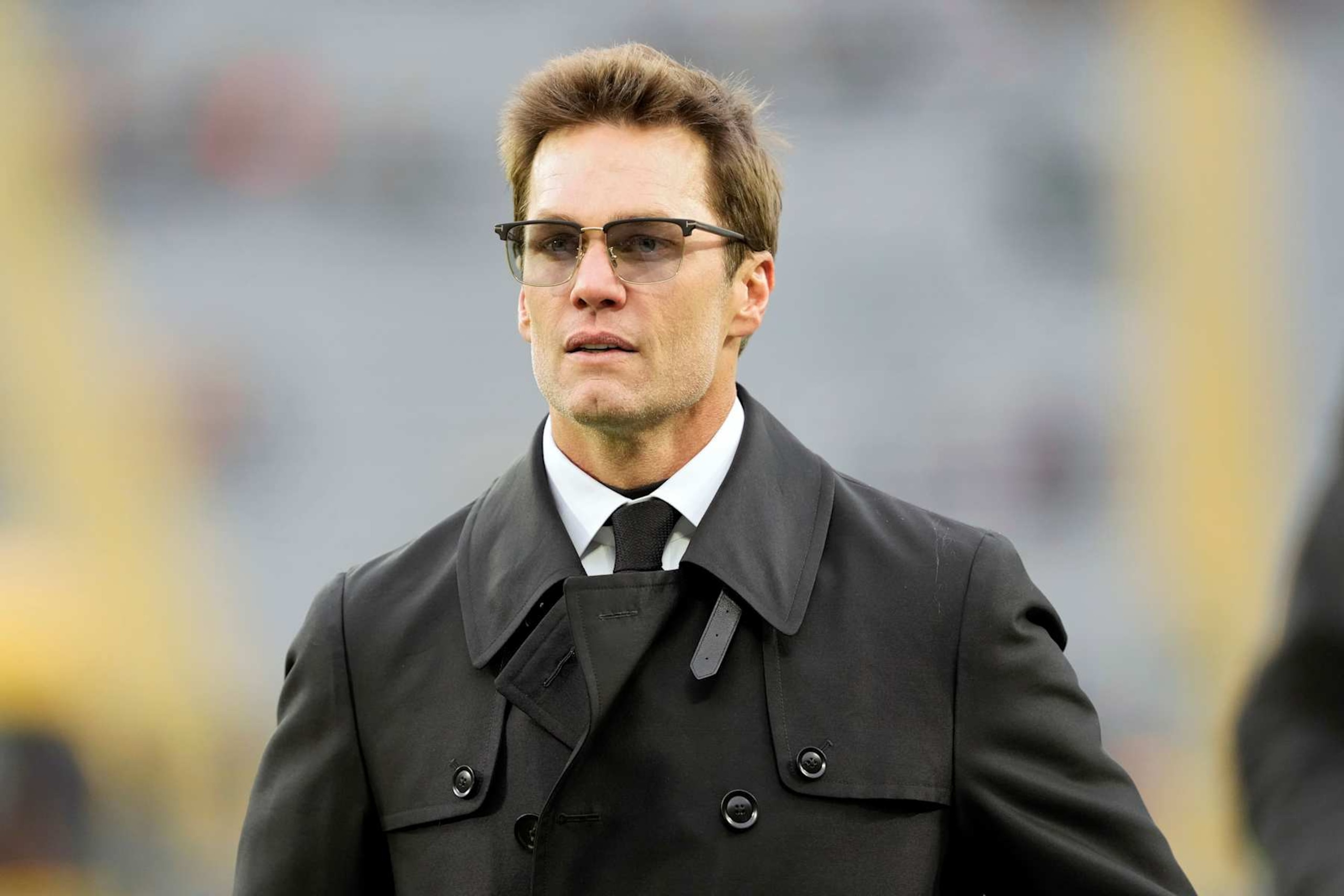 GREEN BAY, WISCONSIN - NOVEMBER 24: Tom Brady walks across the field before the game between the San Francisco 49ers and the Green Bay Packers at Lambeau Field on November 24, 2024 in Green Bay, Wisconsin. (Photo by Patrick McDermott/Getty Images)
