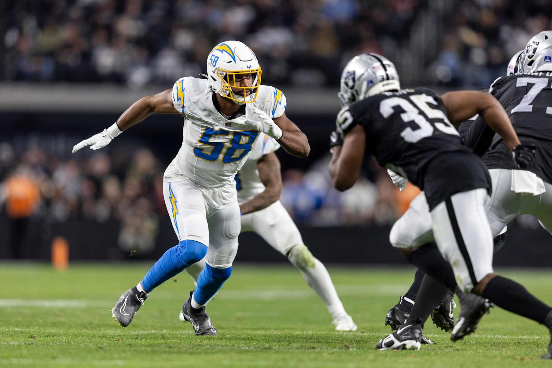 LAS VEGAS, NEVADA - DECEMBER 14: Justin Hollins #58 of the Los Angeles Chargers runs around the edge during an NFL football game between the Las Vegas Raiders and the Los Angeles Chargers at Allegiant Stadium on December 14, 2023 in Las Vegas, Nevada. (Photo by Michael Owens/Getty Images)