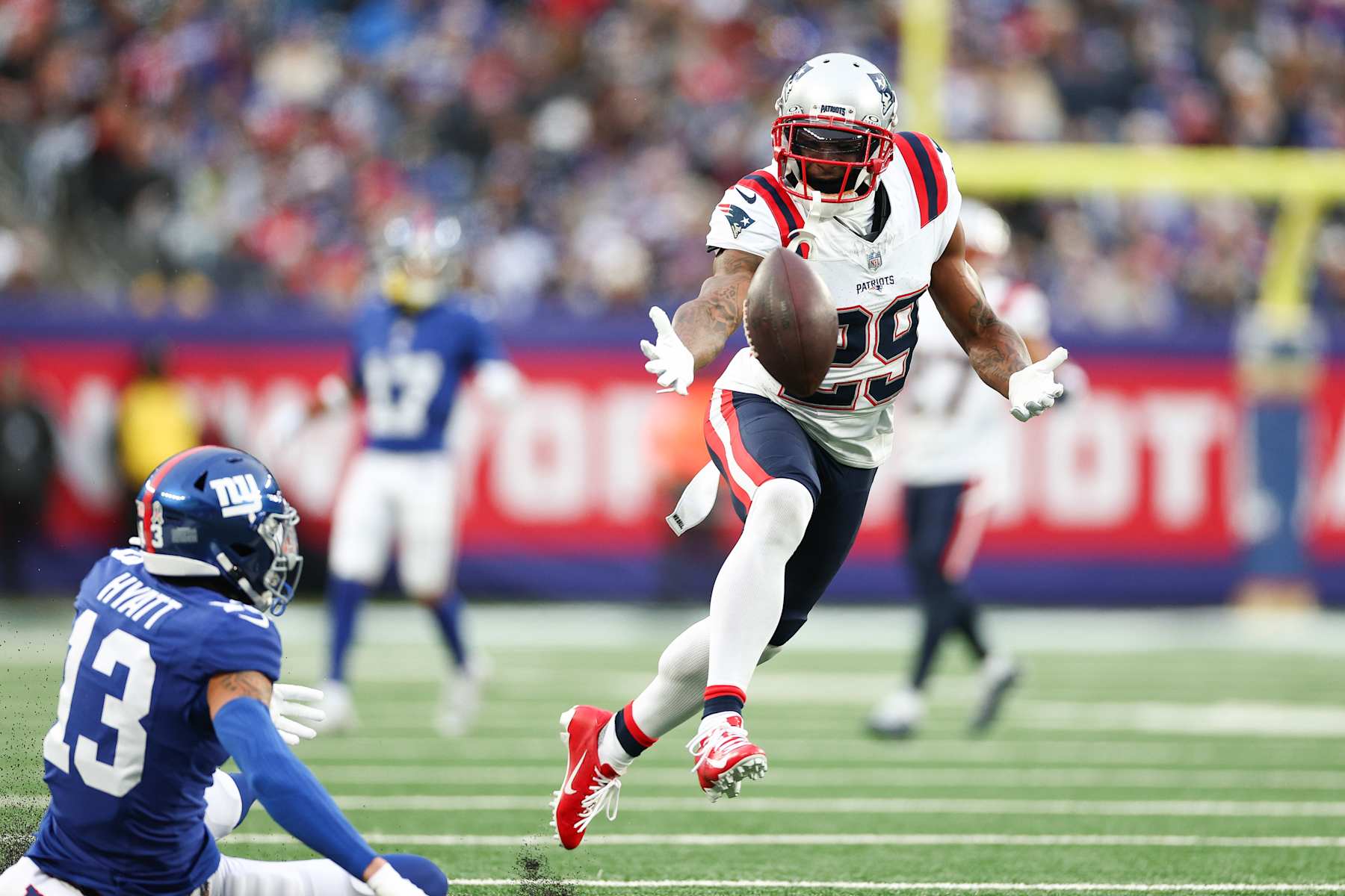 EAST RUTHERFORD, NEW JERSEY - NOVEMBER 26: J.C. Jackson #29 of the New England Patriots attempts to intercept a pass intended for Jalin Hyatt #13 of the New York Giants during the second quarter at MetLife Stadium on November 26, 2023 in East Rutherford, New Jersey. (Photo by Elsa/Getty Images)