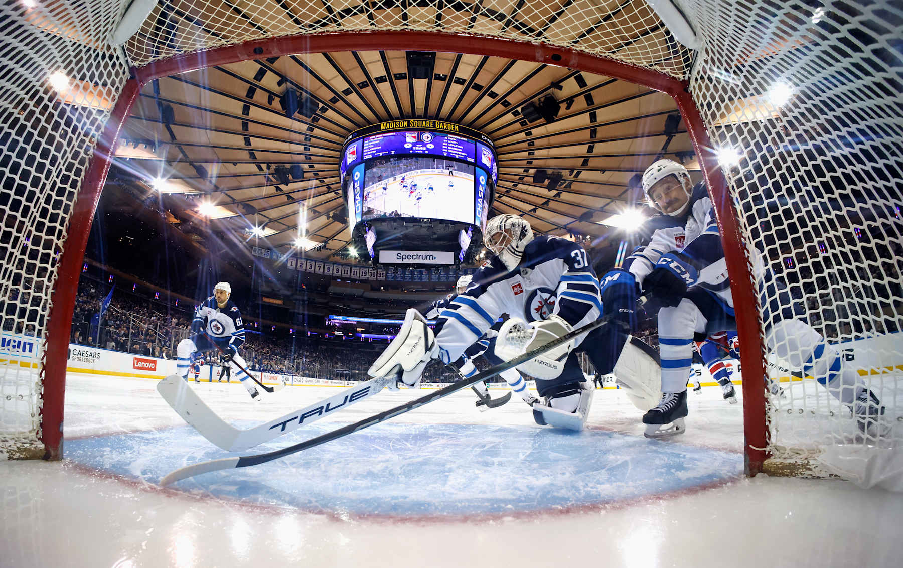 NEW YORK, NEW YORK - NOVEMBER 12: Connor Hellebuyck #37 and Neal Pionk #4 of the Winnipeg Jets defend the net against the New York Rangers at Madison Square Garden on November 12, 2024 in New York City. The Jets defeated the Rangers 6-3. (Photo by Bruce Bennett/Getty Images)