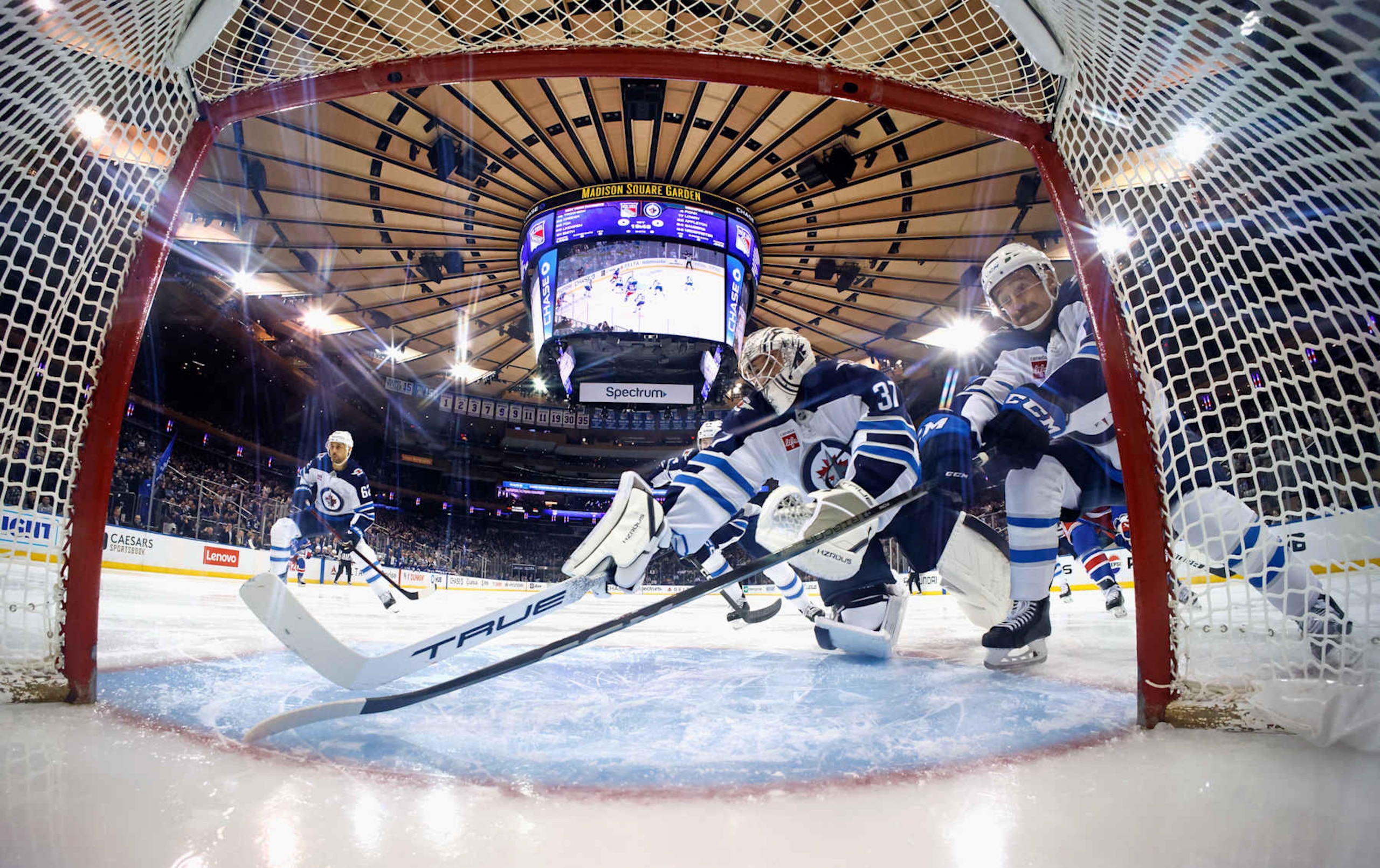NEW YORK, NEW YORK - NOVEMBER 12: Connor Hellebuyck #37 and Neal Pionk #4 of the Winnipeg Jets defend the net against the New York Rangers at Madison Square Garden on November 12, 2024 in New York City. The Jets defeated the Rangers 6-3. (Photo by Bruce Bennett/Getty Images)