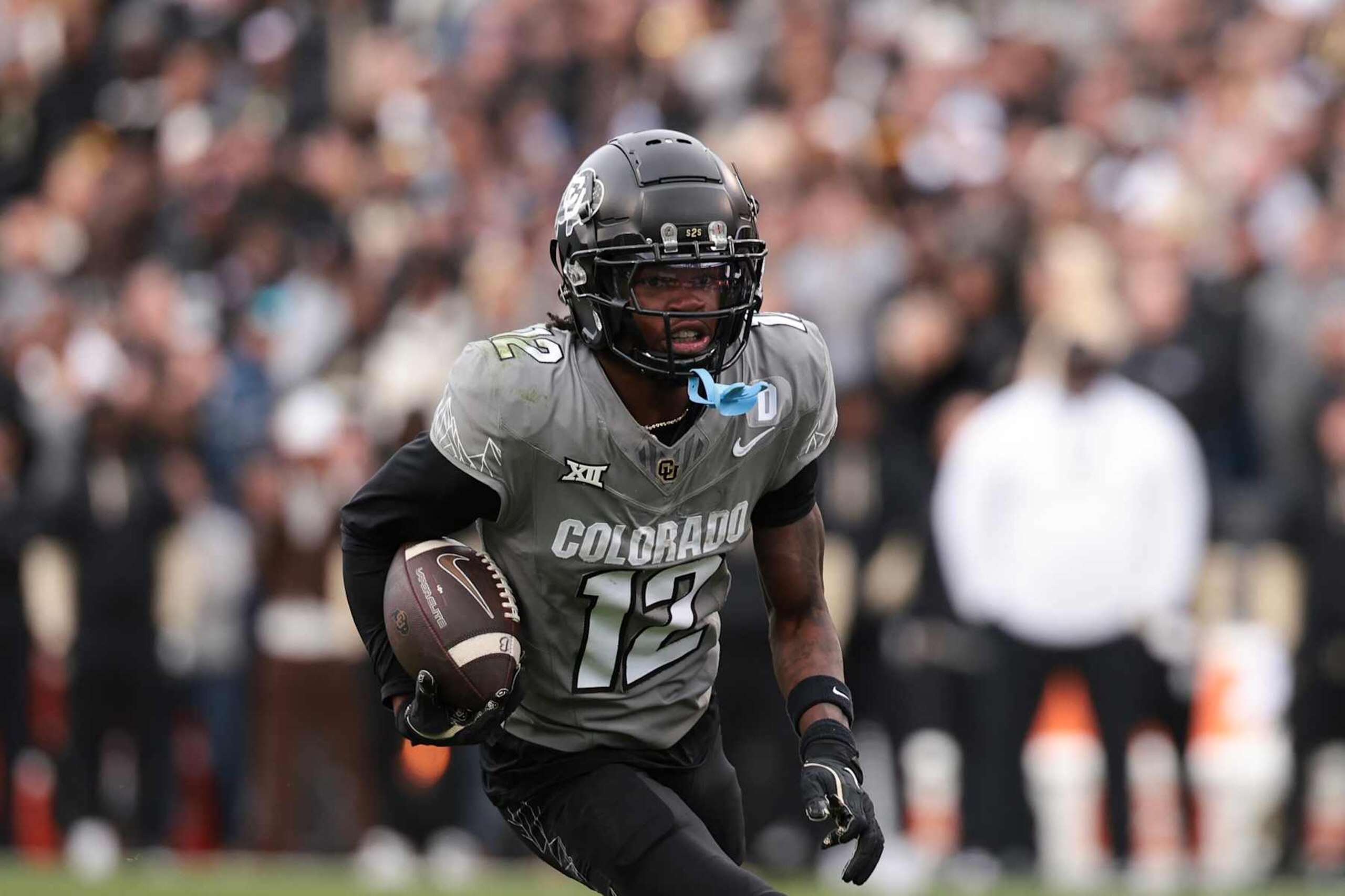 BOULDER, COLORADO - NOVEMBER 16: Travis Hunter #12 of Colorado Buffaloes runs with the ball during the fourth quarter against the Utah Utes at Folsom Field on November 16, 2024 in Boulder, Colorado. (Photo by Andrew Wevers/Getty Images)