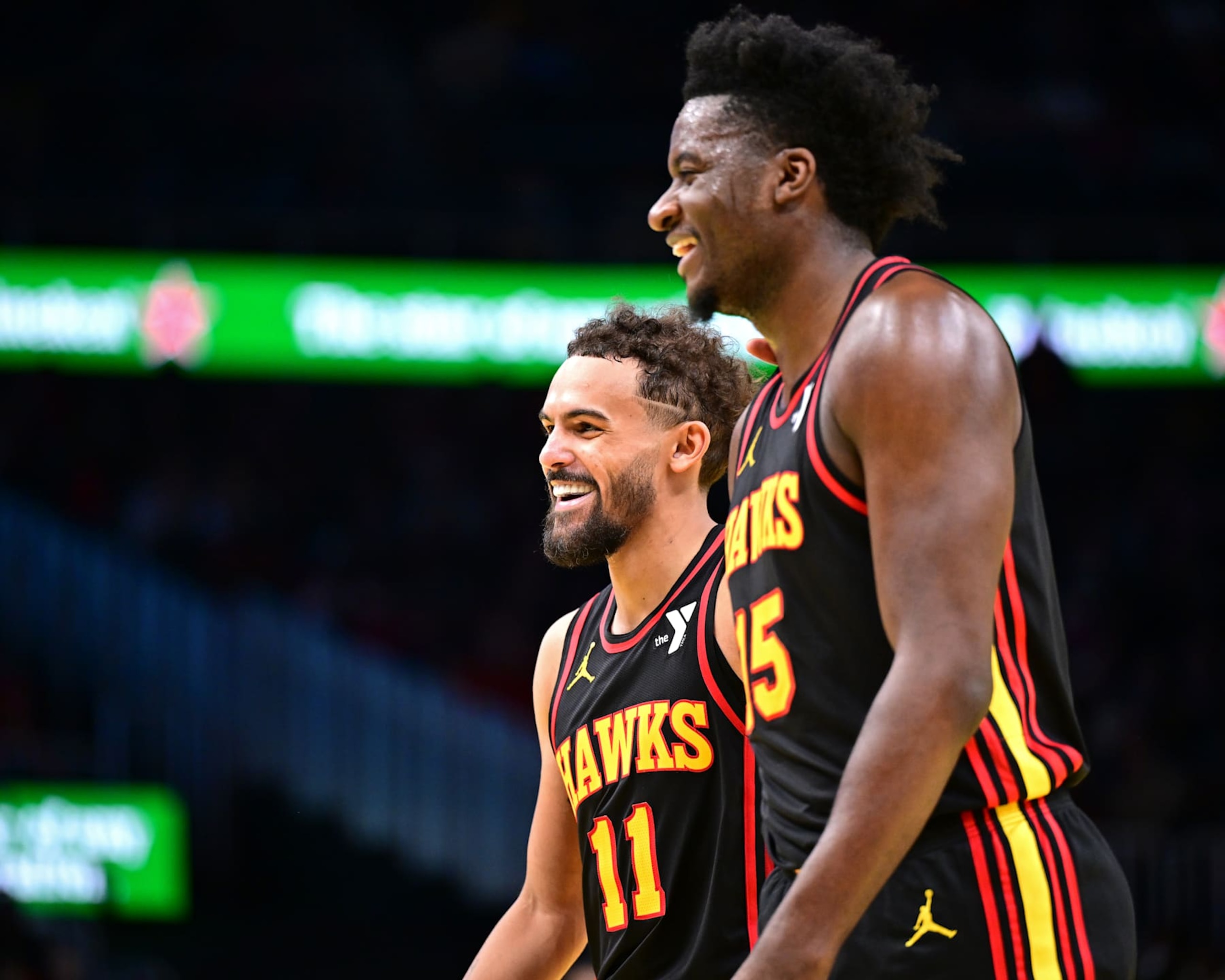 ATLANTA, GA - NOVEMBER 29: Trae Young #11 and Clint Capela #15 of the Atlanta Hawks smile during the game against the Cleveland Cavaliers during the Emirates NBA Cup game on November 29, 2024 at State Farm Arena in Atlanta, Georgia.  NOTE TO USER: User expressly acknowledges and agrees that, by downloading and/or using this Photograph, user is consenting to the terms and conditions of the Getty Images License Agreement. Mandatory Copyright Notice: Copyright 2024 NBAE (Photo by Adam Hagy/NBAE via Getty Images)