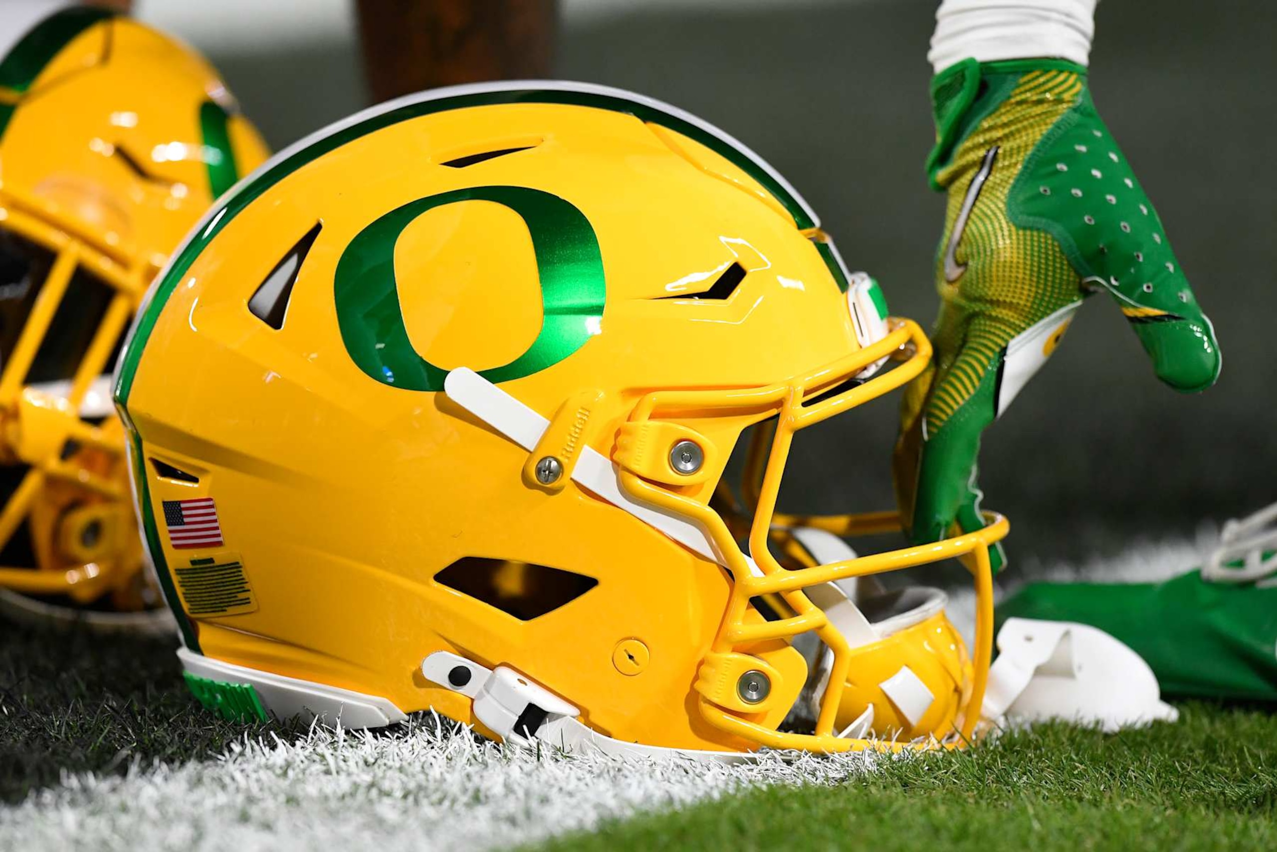 WEST LAFAYETTE, IN - OCTOBER 18: An Oregon Ducks player picks up his helmet before the college football game between the Oregon Ducks and the Purdue Boilermakers on October 18, 2024, at Ross-Ade Stadium in West Lafayette, Indiana. (Photo by Michael Allio/Icon Sportswire via Getty Images)