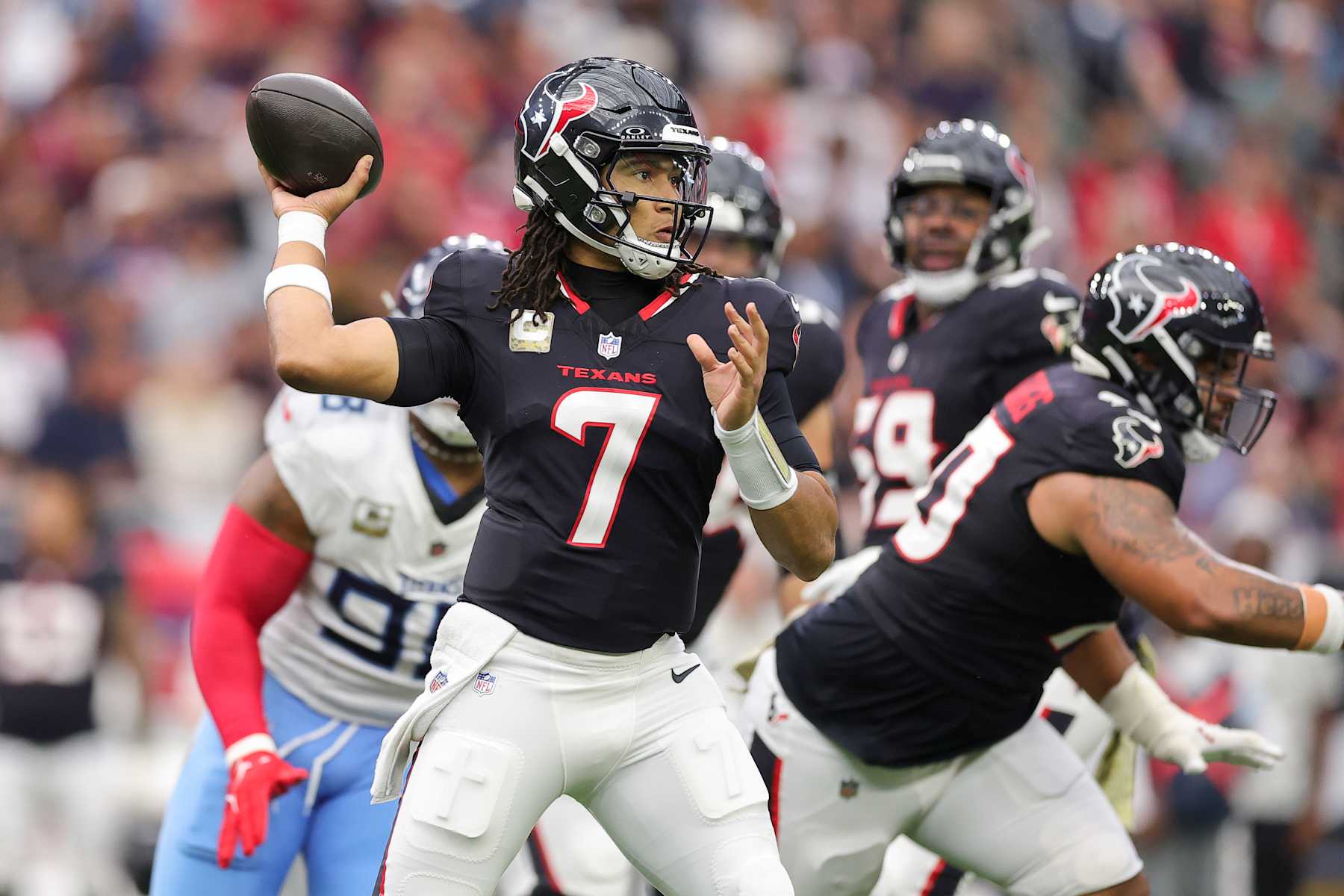HOUSTON, TEXAS - NOVEMBER 24: C.J. Stroud #7 of the Houston Texans drops back to pass against the Tennessee Titans during the first half at NRG Stadium on November 24, 2024 in Houston, Texas. (Photo by Alex Slitz/Getty Images)