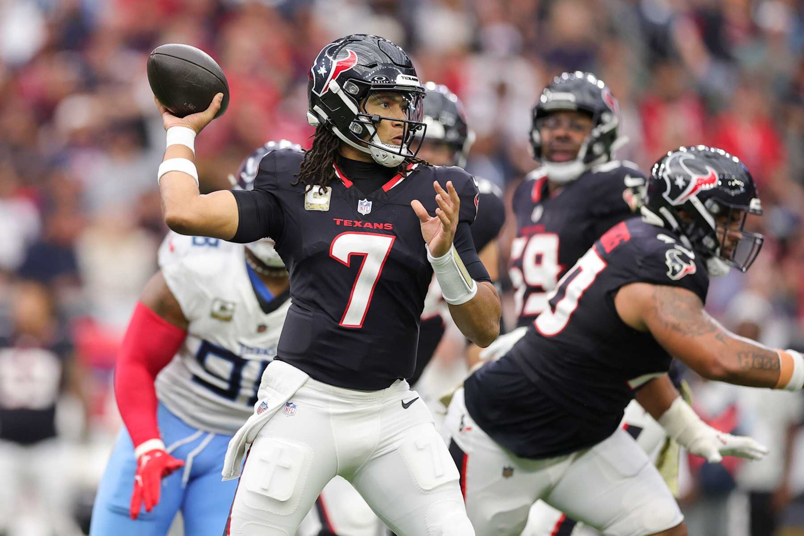 HOUSTON, TEXAS - NOVEMBER 24: C.J. Stroud #7 of the Houston Texans drops back to pass against the Tennessee Titans during the first half at NRG Stadium on November 24, 2024 in Houston, Texas. (Photo by Alex Slitz/Getty Images)