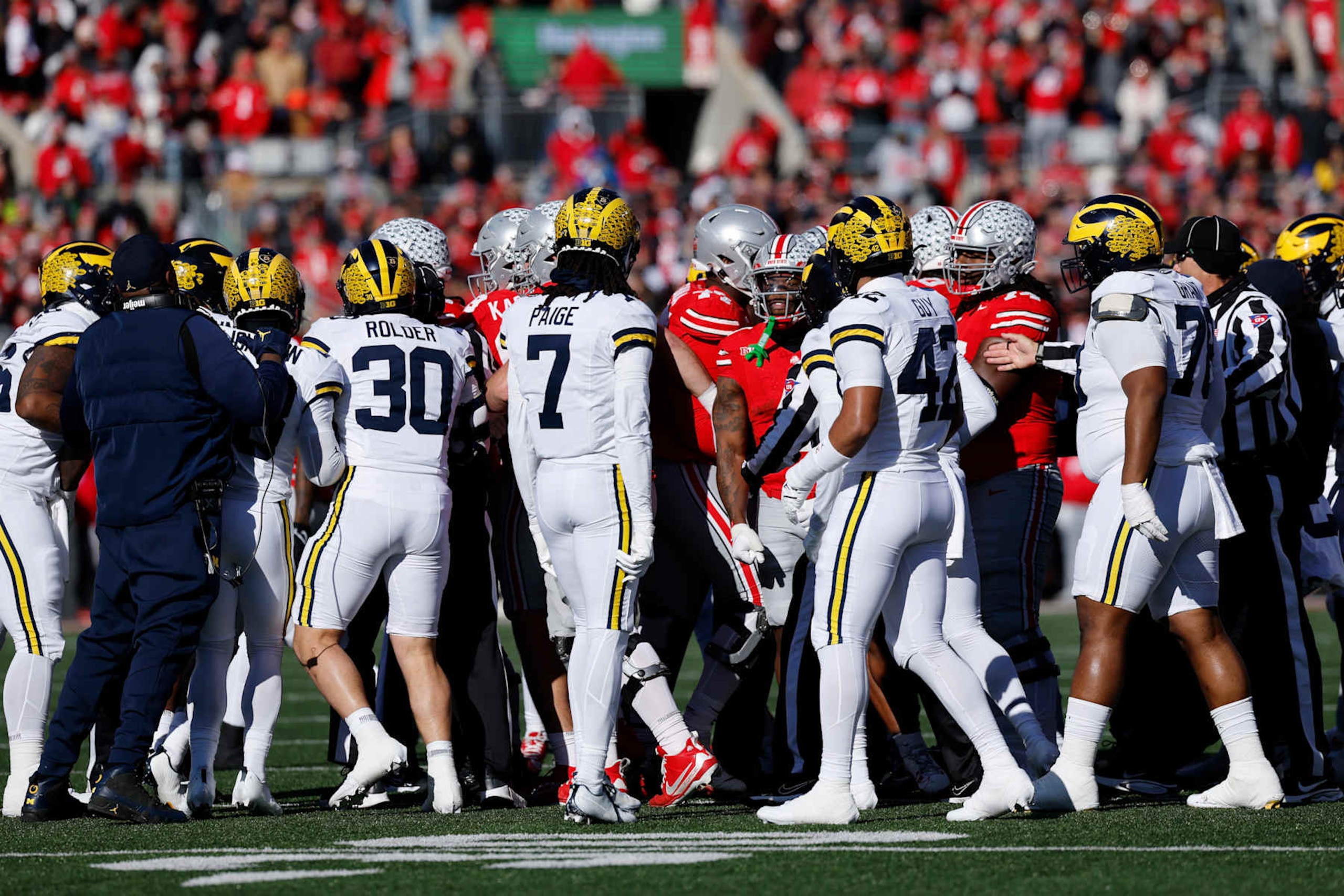 COLUMBUS, OH - NOVEMBER 30: Coaches try to separate Michigan Wolverines and Ohio State Buckeyes players after a skirmish during a college football game on November 30, 2024 at Ohio Stadium in Columbus, Ohio. (Photo by Joe Robbins/Icon Sportswire via Getty Images)