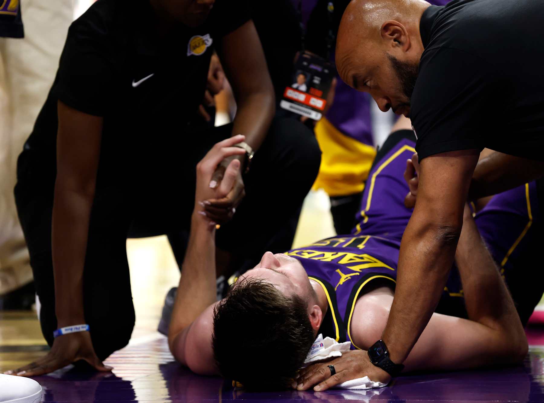 LOS ANGELES, CALIFORNIA - NOVEMBER 29: Austin Reaves #15 of the Los Angeles Lakers is treated after an apparent injury against the Oklahoma City Thunder during the second quarter of the Emirates NBA Cup at Crypto.com Arena on November 29, 2024 in Los Angeles, California. NOTE TO USER: User expressly acknowledges and agrees that, by downloading and or using this photograph, User is consenting to the terms and conditions of the Getty Images License Agreement. (Photo by Ronald Martinez/Getty Images)
