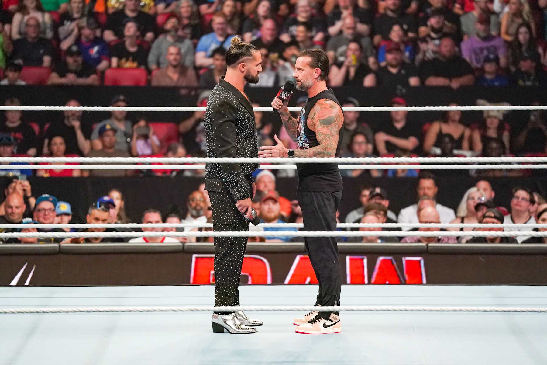 OTTAWA, CANADA - JULY 8: Seth Rollins and CM Punk have a chat in the ring during Monday Night RAW at Canadian Tire Centre on July 8, 2024 in Ottawa, Ontario.  (Photo by WWE/Getty Images)
