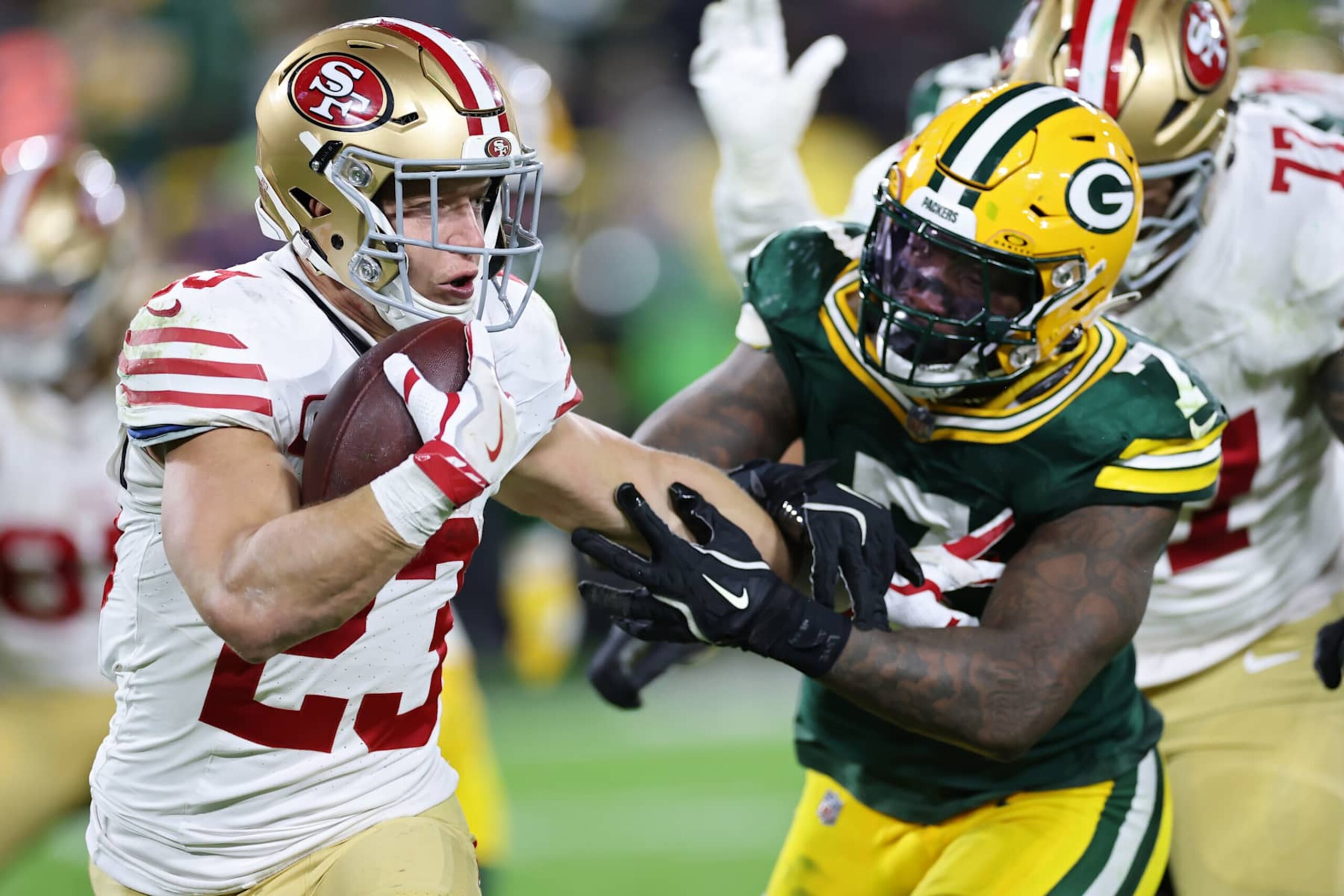 GREEN BAY, WISCONSIN - NOVEMBER 24: Christian McCaffrey #23 of the San Francisco 49ers runs with the ball while being chased by Quay Walker #7 of the Green Bay Packers in the third quarter at Lambeau Field on November 24, 2024 in Green Bay, Wisconsin. (Photo by Stacy Revere/Getty Images)
