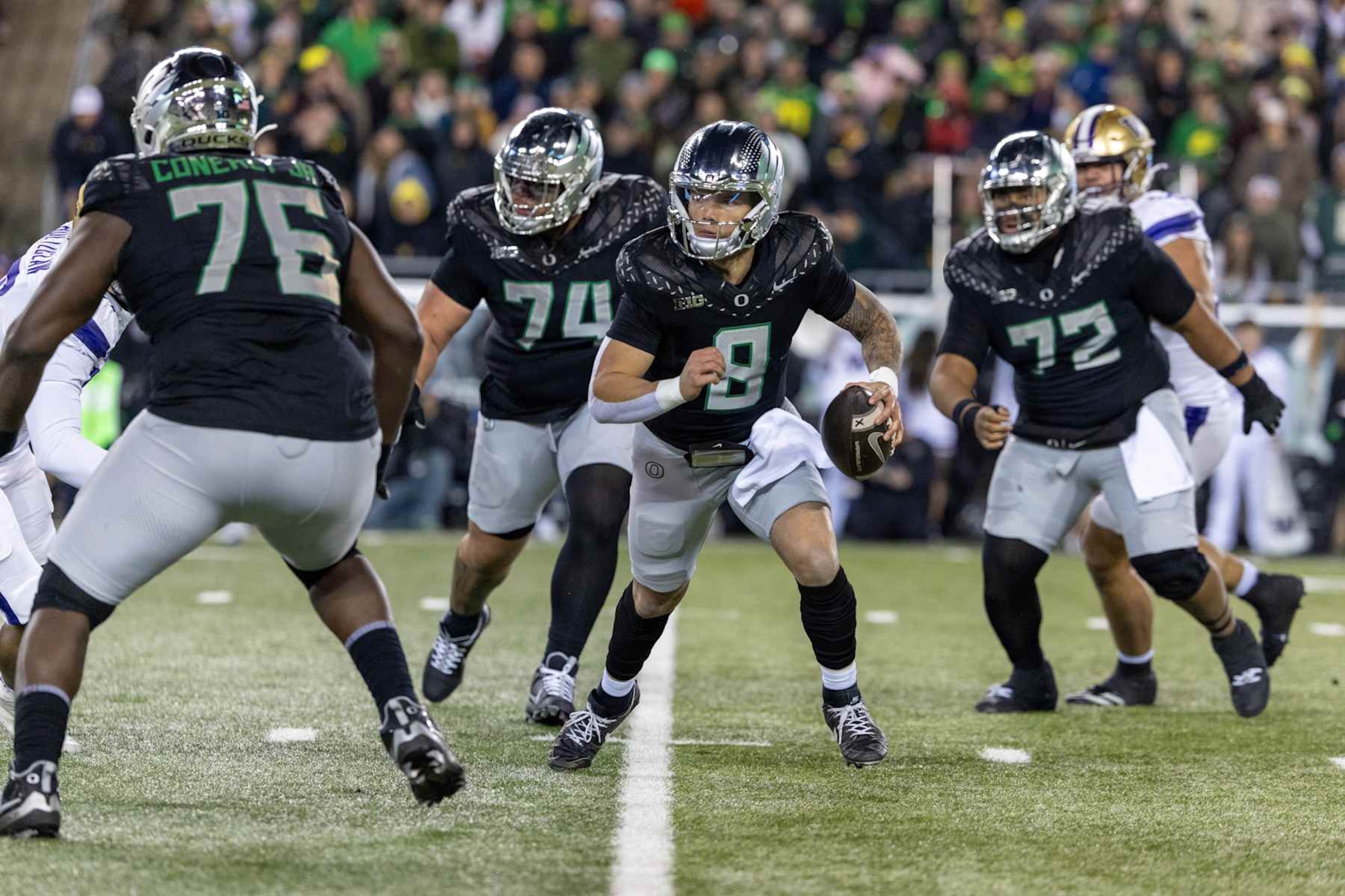 EUGENE, OREGON - NOVEMBER 30: Quarterback Dillon Gabriel #8 of the Oregon Ducks runs to pass the ball in the first half against the Washington Huskies at Autzen Stadium on November 30, 2024 in Eugene, Oregon.  (Photo by Tom Hauck/Getty Images)