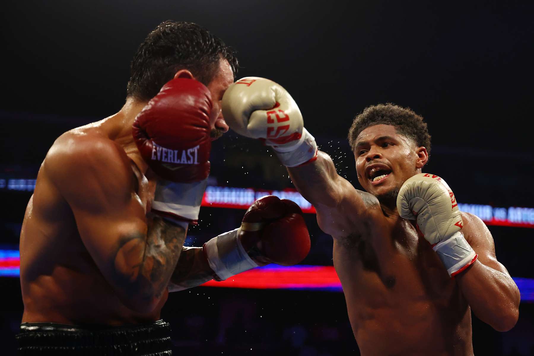NEWARK, NEW JERSEY - JULY 06: Shakur Stevenson (gold gloves) trades punches with Artem Harutyunyan of Germany (red gloves) during their WBC Lightweight World Title fight at Prudential Center on July 06, 2024 in Newark, New Jersey. (Photo by Sarah Stier/Getty Images)