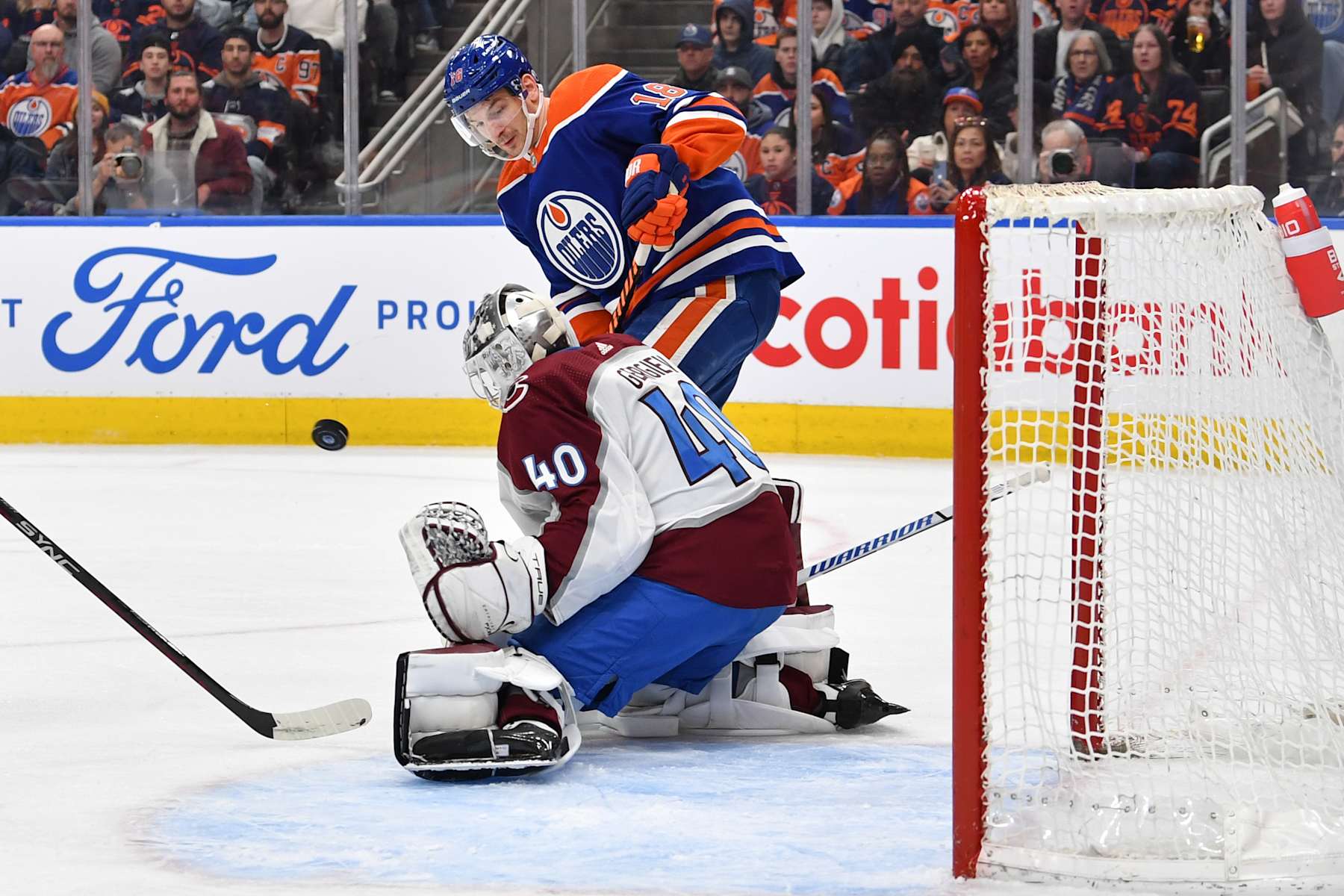 Colorado Avalanche goaltender Alexandar Georgiev makes a save on Edmonton Oilers winger Zach Hyman.