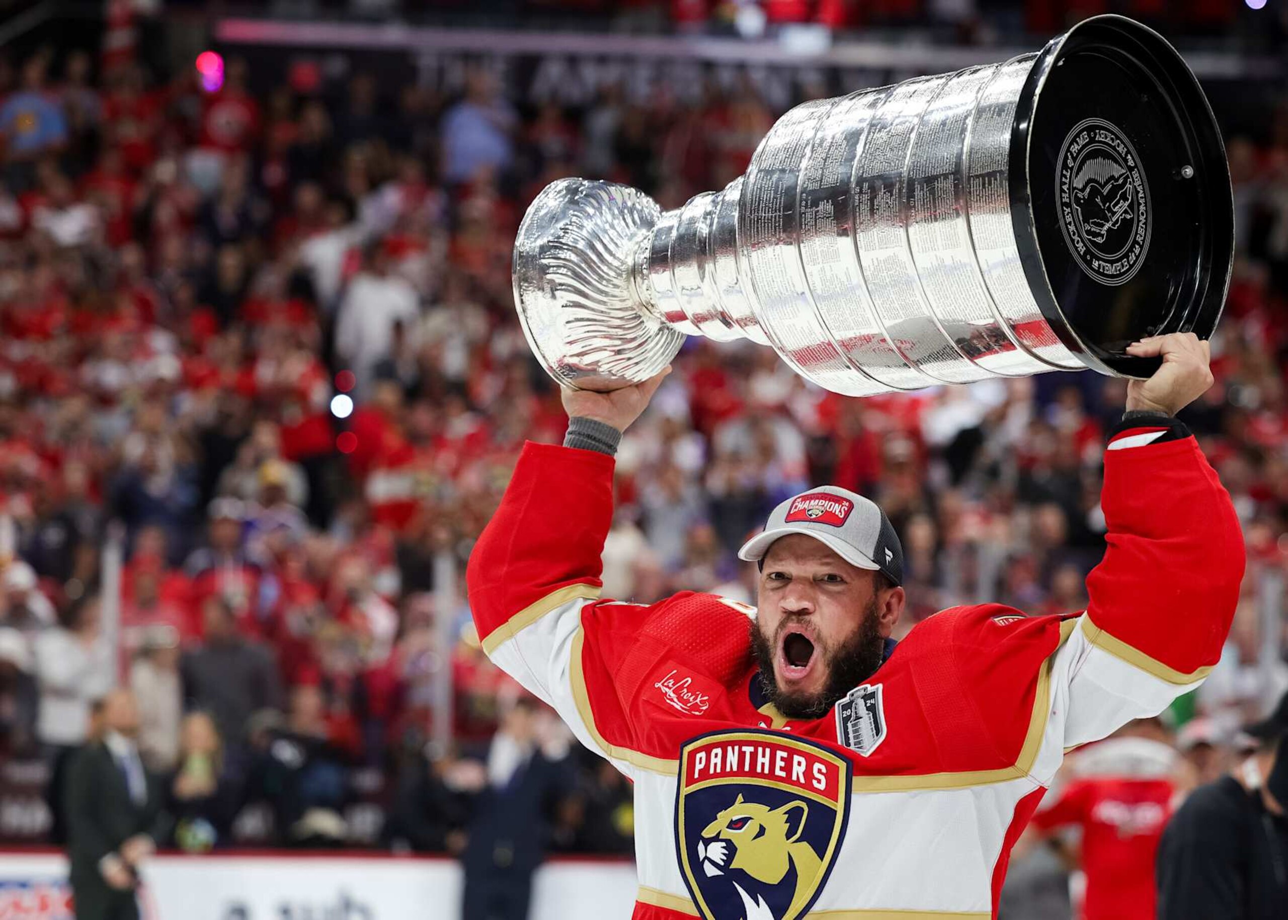 SUNRISE, FLORIDA - JUNE 24: Kyle Okposo #8 of the Florida Panthers hoists the Stanley Cup after Florida's 2-1 victory against the Edmonton Oilers in Game Seven of the 2024 Stanley Cup Final at Amerant Bank Arena on June 24, 2024 in Sunrise, Florida.  (Photo by Carmen Mandato/Getty Images)