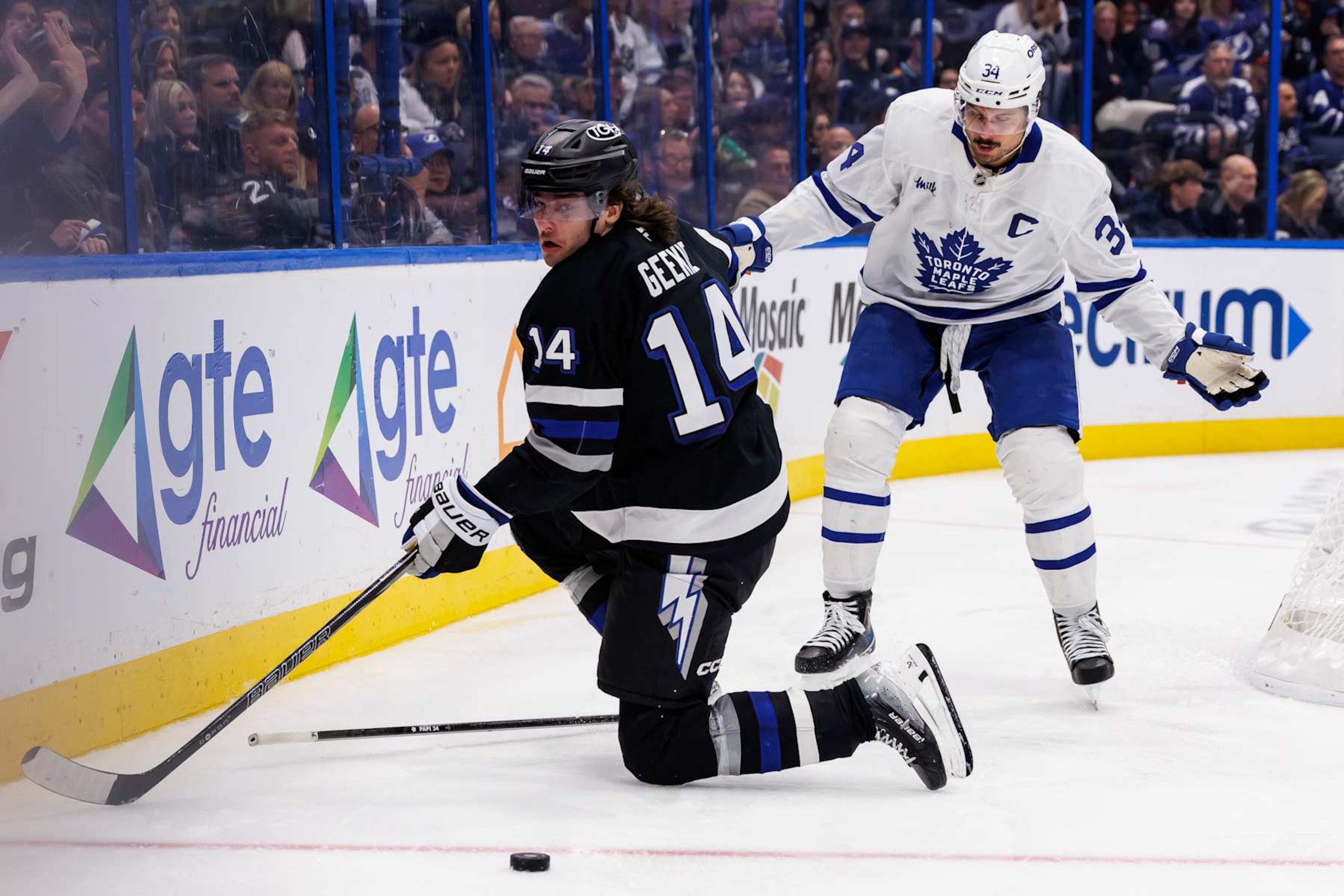TAMPA, FL - NOVEMBER 30: Conor Geekie #14 of the Tampa Bay Lightning skates against Auston Matthews #34 of the Toronto Maple Leafs at Amalie Arena on November 30, 2024 in Tampa, Florida. (Photo by Mark LoMoglio/NHLI via Getty Images)