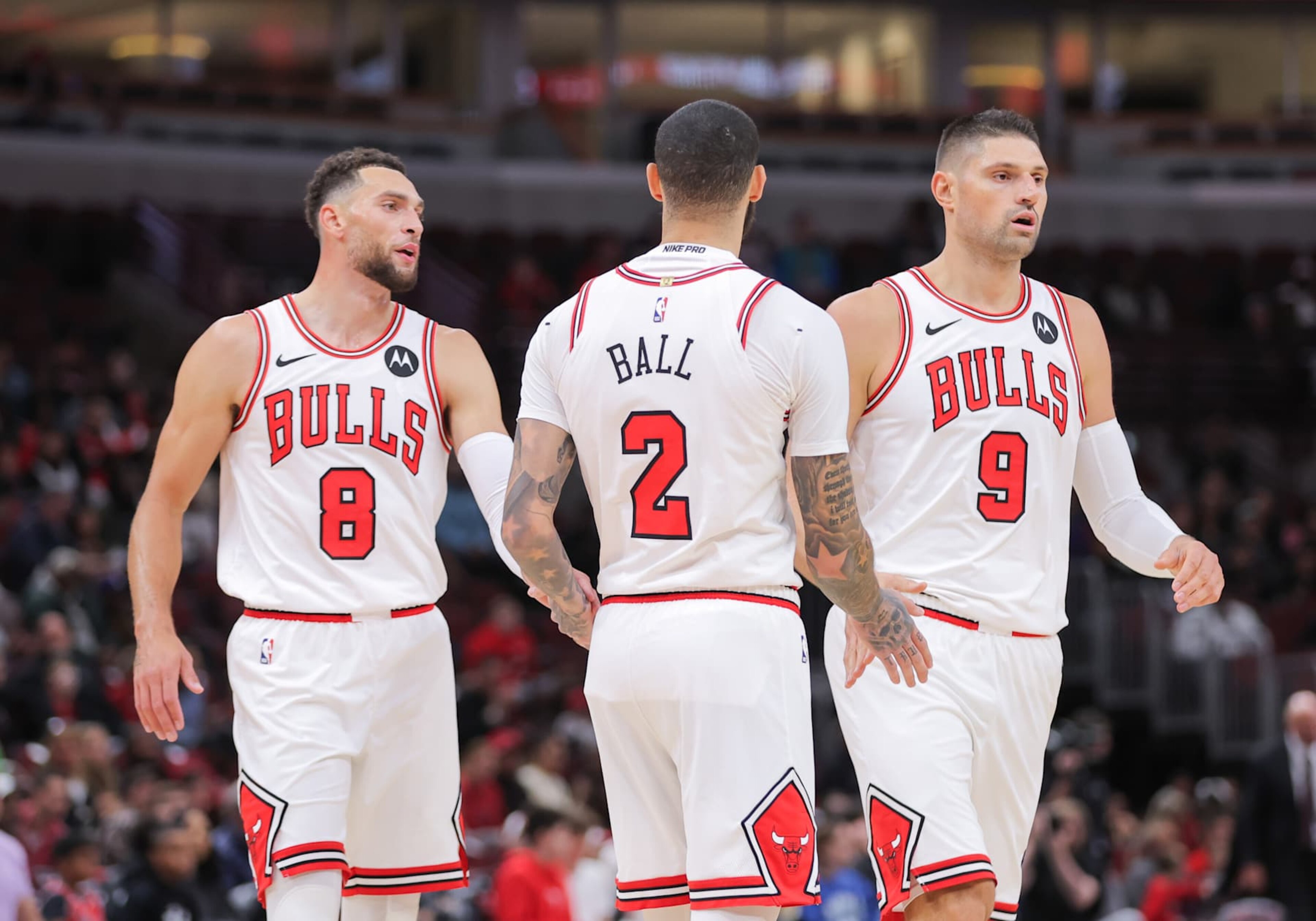 CHICAGO, IL - OCTOBER 16: Chicago Bulls guard Lonzo Ball (2) high vies Chicago Bulls guard Zach LaVine (8) and Chicago Bulls center Nikola Vucevic (9) during the first half of a preseason game on October 16, 2024 at the United Center in Chicago, Illinois. (Photo by Melissa Tamez/Icon Sportswire via Getty Images) CHICAGO, IL - OCTOBER 16: Chicago Bulls guard Lonzo Ball (2) high vies Chicago Bulls guard Zach LaVine (8) and Chicago Bulls center Nikola Vucevic (9) during the first half of a preseason game on October 16, 2024 at the United Center in Chicago, Illinois. (Photo by Melissa Tamez/Icon Sportswire via Getty Images)