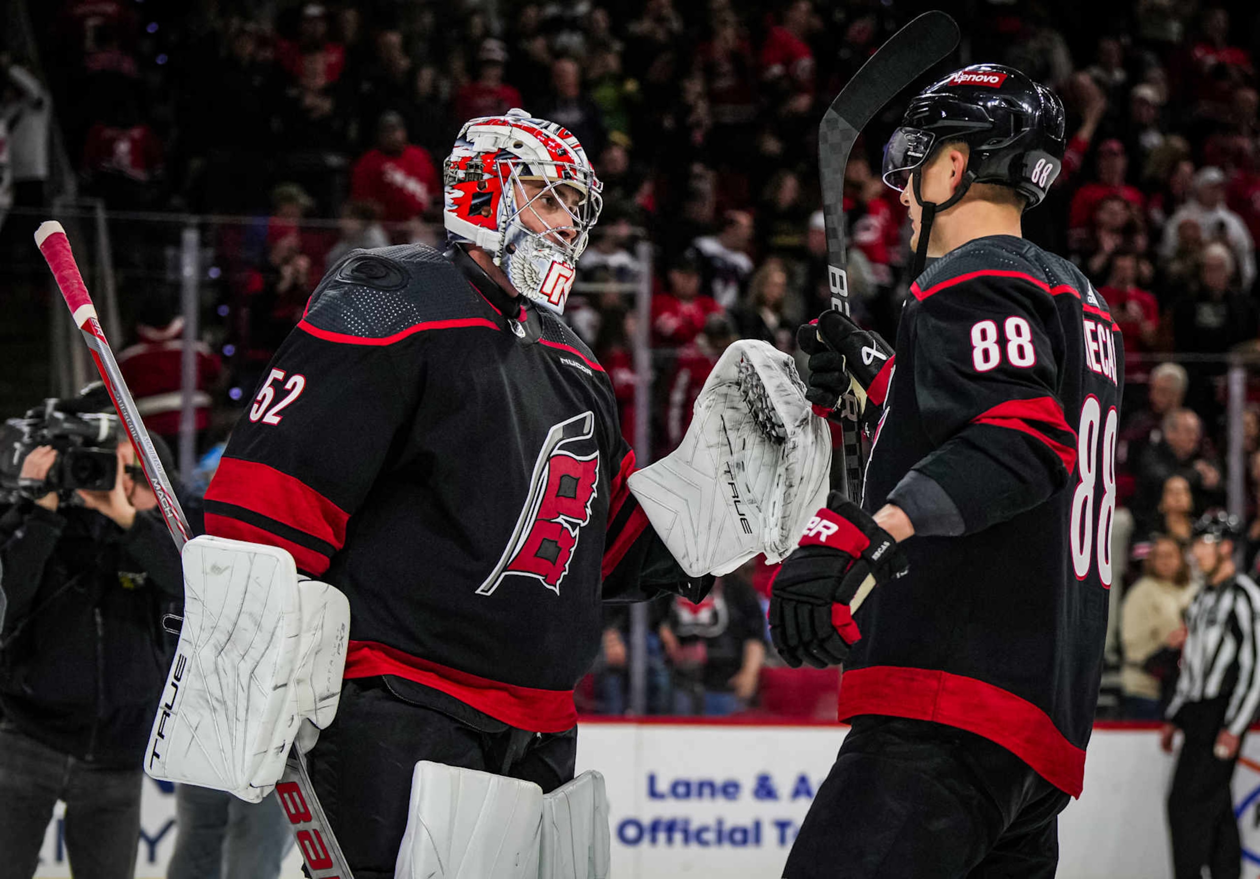 RALEIGH, NORTH CAROLINA - APRIL 05:  Pyotr Kochetkov #52 of the Carolina Hurricanes celebrates with Martin Necas #88 after a 4-2 victory against the Washington Capitals at PNC Arena on April 5, 2024 in Raleigh, North Carolina. (Photo by Josh Lavallee/NHLI via Getty Images)