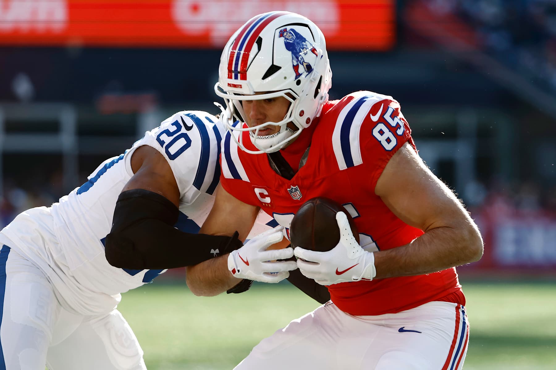 FOXBOROUGH, MASSACHUSETTS - DECEMBER 01: Hunter Henry #85 of the New England Patriots tries to break a tackle by Nick Cross #20 of the Indianapolis Colts in the first quarter of a game at Gillette Stadium on December 01, 2024 in Foxborough, Massachusetts. (Photo by Winslow Townson/Getty Images)