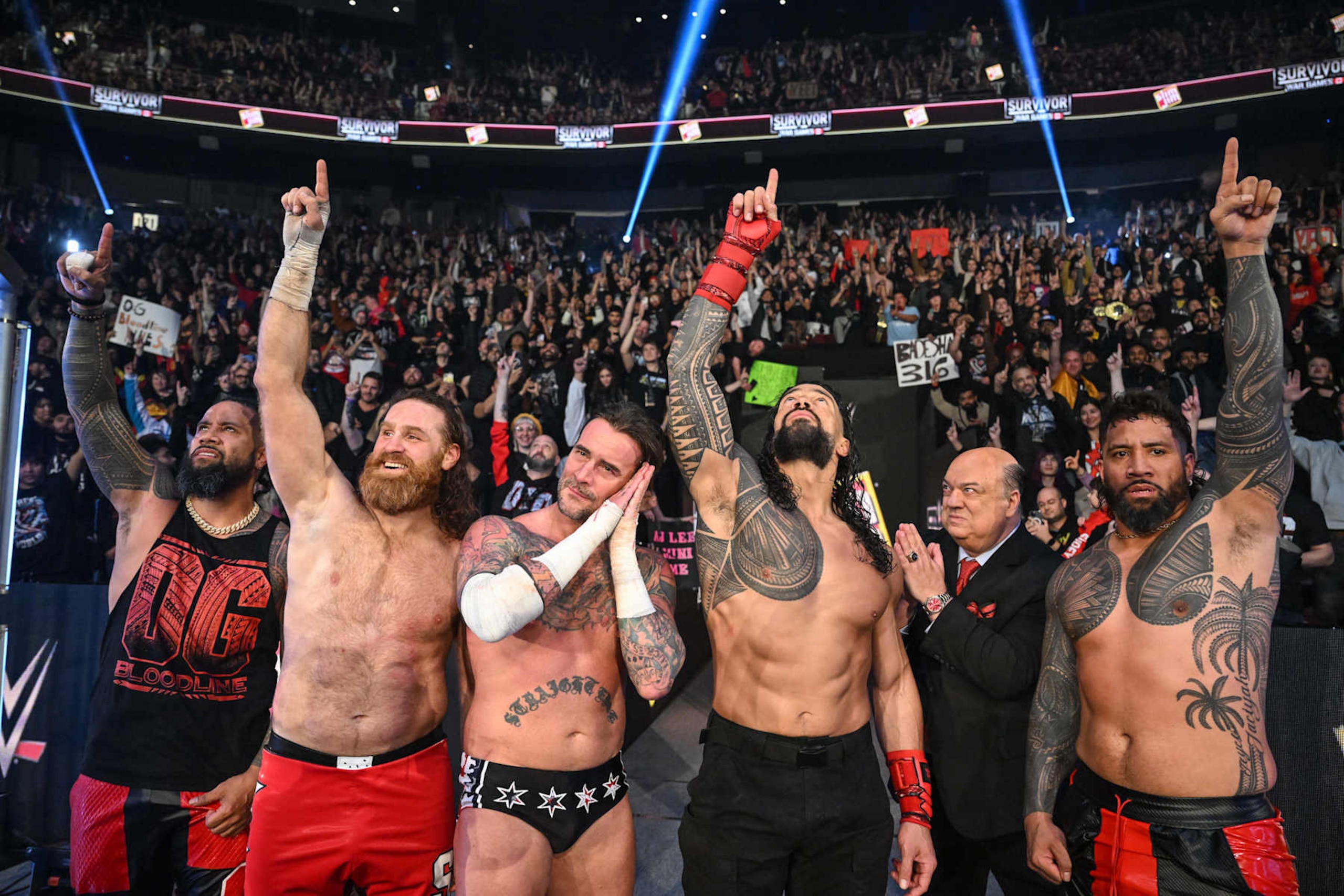 VANCOUVER, CANADA - NOVEMBER 30: Jimmy Uso, Sami Zayn, CM Punk, Roman Reigns, Paul Heyman, and Jey Uso celebrate their victory during WWE Survivor Series: War Games at Rogers Arena on November 30, 2024 in Vancouver, Canada.  (Photo by WWE/Getty Images)