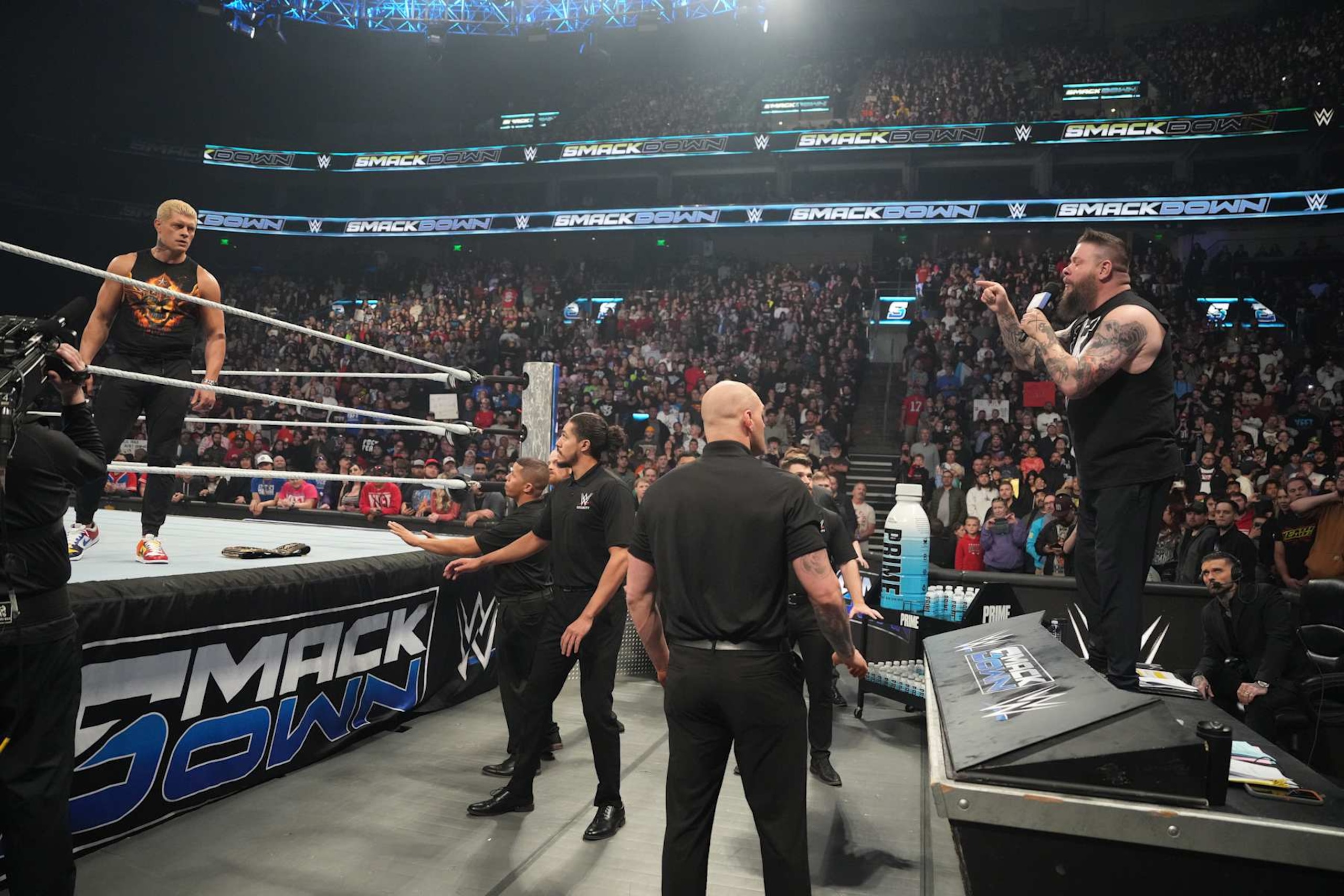 SALT LAKE CITY, UTAH - NOVEMBER 22: Kevin Owens on the microphone and Cody Rhodes during WWE SmackDown at Delta Center on November 22, 2024 in Salt Lake City, Utah.  (Photo by WWE/Getty Images)
