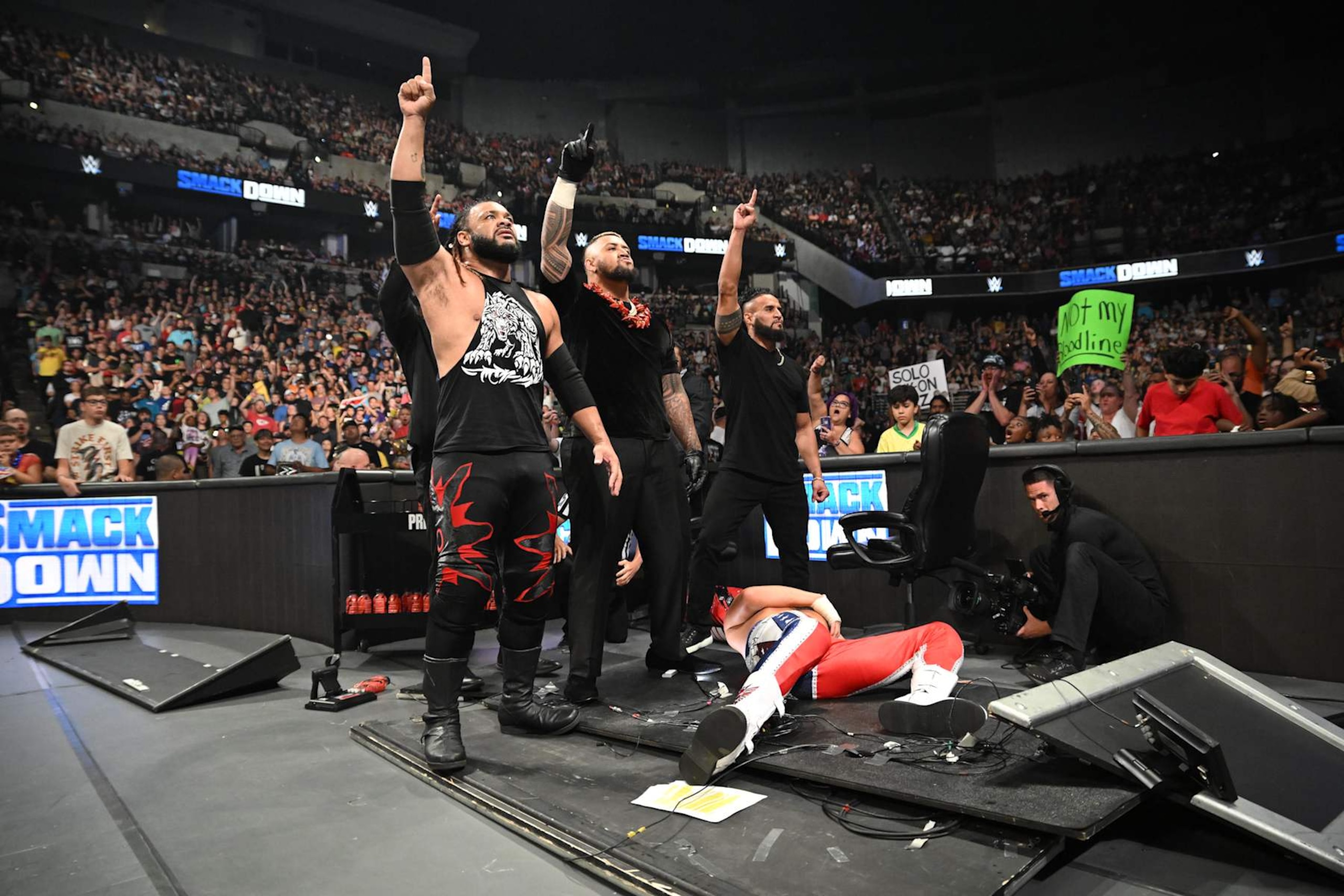 OMAHA, NEBRASKA - JULY 19: Jacob Fatu, Solo Sikoa and Tama Tonga stand over Cody Rhodes during SmackDown at CHI Health Center on July 19, 2024 in Omaha, Nebraska.  (Photo by WWE/Getty Images)