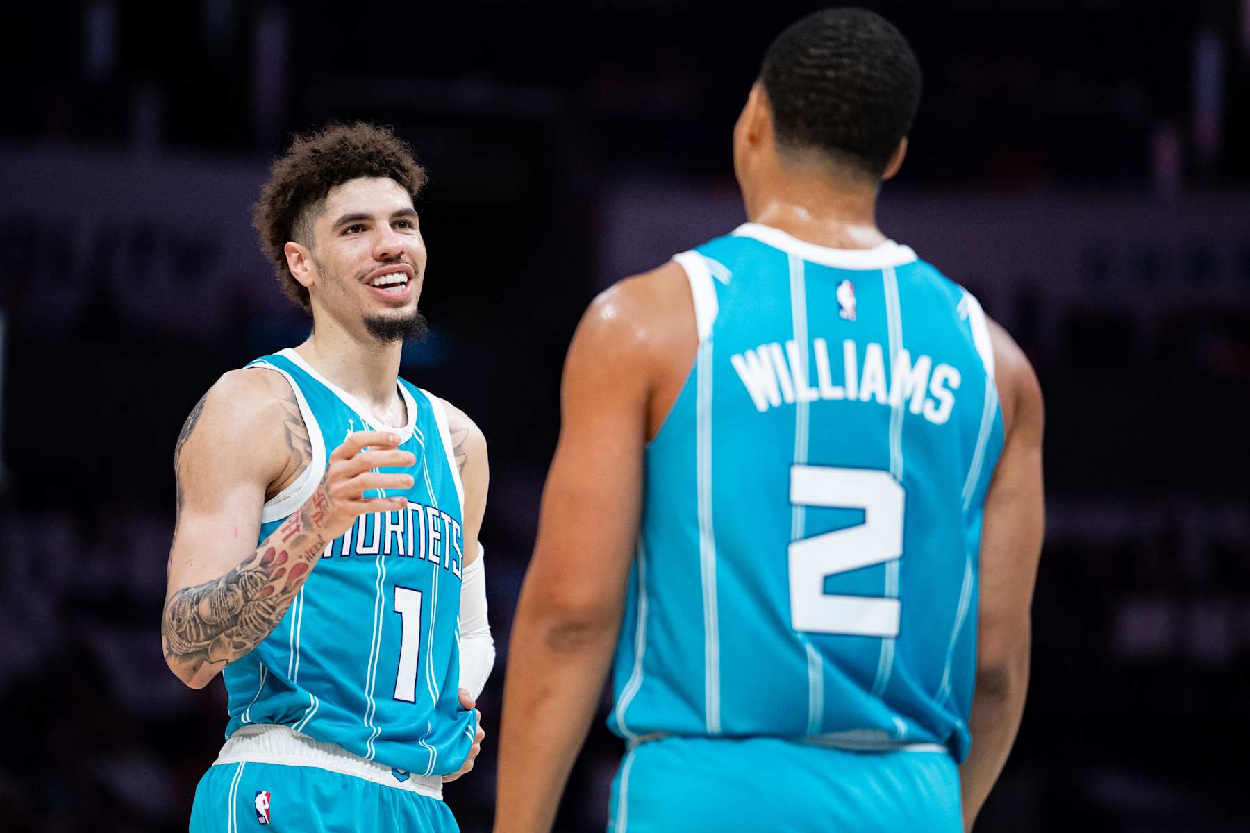 CHARLOTTE, NORTH CAROLINA - OCTOBER 26: LaMelo Ball #1 talks with Grant Williams #2 of the Charlotte Hornets during their game against the Miami Heat at Spectrum Center on October 26, 2024 in Charlotte, North Carolina. NOTE TO USER: User expressly acknowledges and agrees that, by downloading and or using this photograph, User is consenting to the terms and conditions of the Getty Images License Agreement. (Photo by Jacob Kupferman/Getty Images)