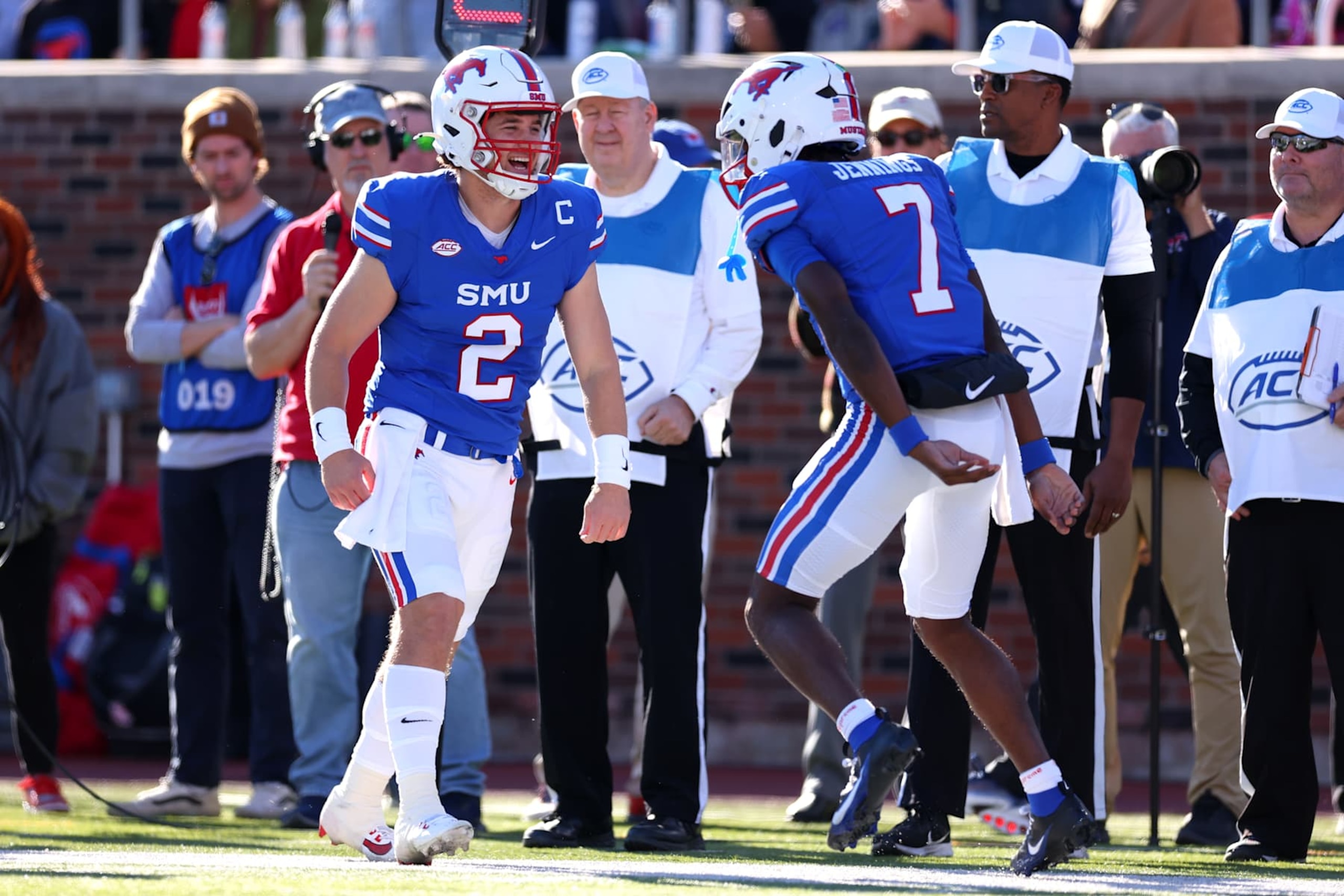 DALLAS, TEXAS - NOVEMBER 30: Preston Stone #2 celebrates with Kevin Jennings #7 of the Southern Methodist Mustangs after a touchdown during the first half against the California Golden Bears at Gerald J. Ford Stadium on November 30, 2024 in Dallas, Texas. (Photo by Sam Hodde/Getty Images)
