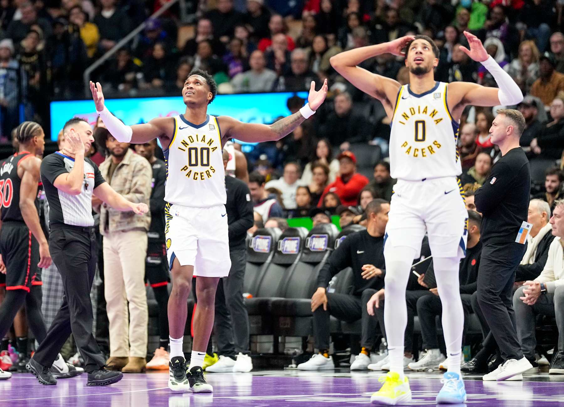 TORONTO, ON - DECEMBER 3: Bennedict Mathurin #00 of the Indiana Pacers and Tyrese Haliburton #0 look up to the scoreboard during the second half against the Toronto Raptors during the Emirates NBA Cup game at the Scotiabank Arena on December 3, 2024 in Toronto, Ontario, Canada. NOTE TO USER: User expressly acknowledges and agrees that, by downloading and/or using this Photograph, user is consenting to the terms and conditions of the Getty Images License Agreement. (Photo by Kevin Sousa/Getty Images)