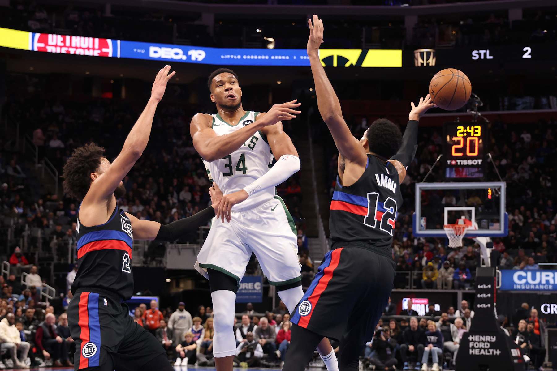 DETROIT, MICHIGAN - DECEMBER 03: Giannis Antetokounmpo #34 of the Milwaukee Bucks passes around Tobias Harris #12 of the Detroit Pistons during the first half of a NBA Cup game at Little Caesars Arena on December 03, 2024 in Detroit, Michigan. NOTE TO USER: User expressly acknowledges and agrees that, by downloading and or using this photograph, User is consenting to the terms and conditions of the Getty Images License. (Photo by Gregory Shamus/Getty Images)