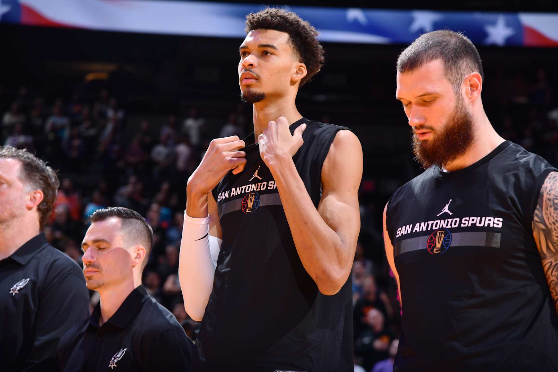 PHOENIX, AZ - DECEMBER 3: Victor Wembanyama #1 of the San Antonio Spurs stands for the National Anthem before the game against the Phoenix Suns during a Emirates NBA Cup game on December 3, 2024 at Footprint Center in Phoenix, Arizona. NOTE TO USER: User expressly acknowledges and agrees that, by downloading and or using this photograph, user is consenting to the terms and conditions of the Getty Images License Agreement. Mandatory Copyright Notice: Copyright 2024 NBAE (Photo by Barry Gossage/NBAE via Getty Images)