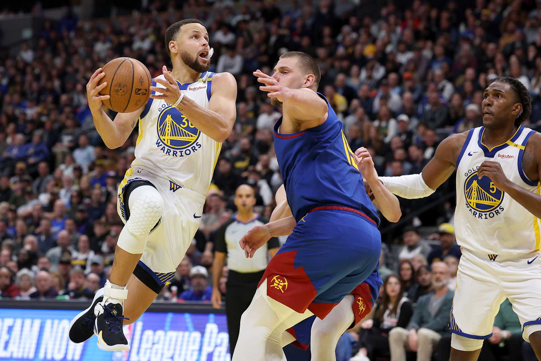DENVER, COLORADO - DECEMBER 03: Stephen Curry #30 of the Golden State Warriors drives against Nikola Jokic #15 of the Denver Nuggets in the fourth quarter of the Emirates NBA Cup at Ball Arena on December 3, 2024 in Denver, Colorado. NOTE TO USER: User expressly acknowledges and agrees that, by downloading and or using this photograph, User is consenting to the terms and conditions of the Getty Images License Agreement.  (Photo by Matthew Stockman/Getty Images)
